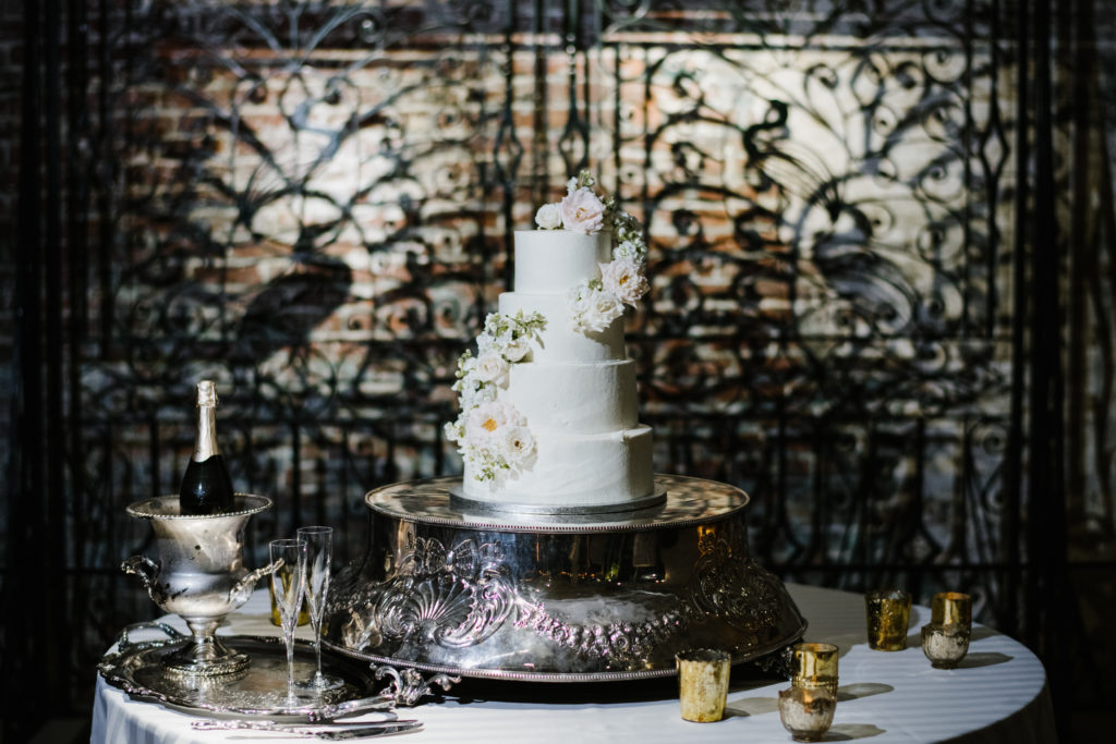 The wedding cake sits atop a very special silver cake stand used by caterer Jack Brantley at all four Watson daughter weddings.