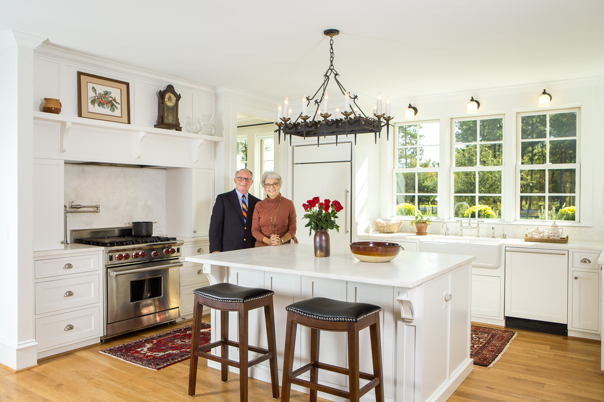 Linda and Glenn enjoy their kitchen. The iron chandelier was purchased from interior designer Mary Miller after one of her buying trips to France. 