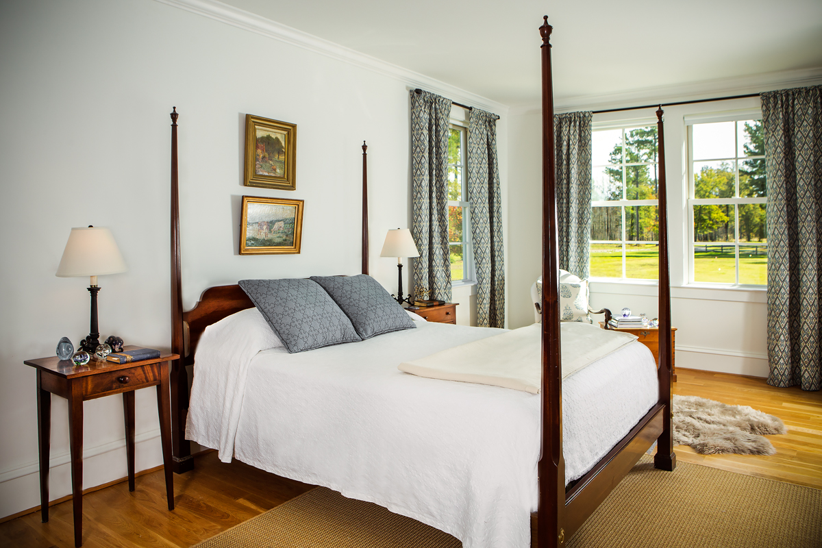 The master bedroom is a mixture of Colonial and modern with the touch of a sheep’s skin rug. Beautiful vistas exist from every window, spreading light and warmth throughout the space. 