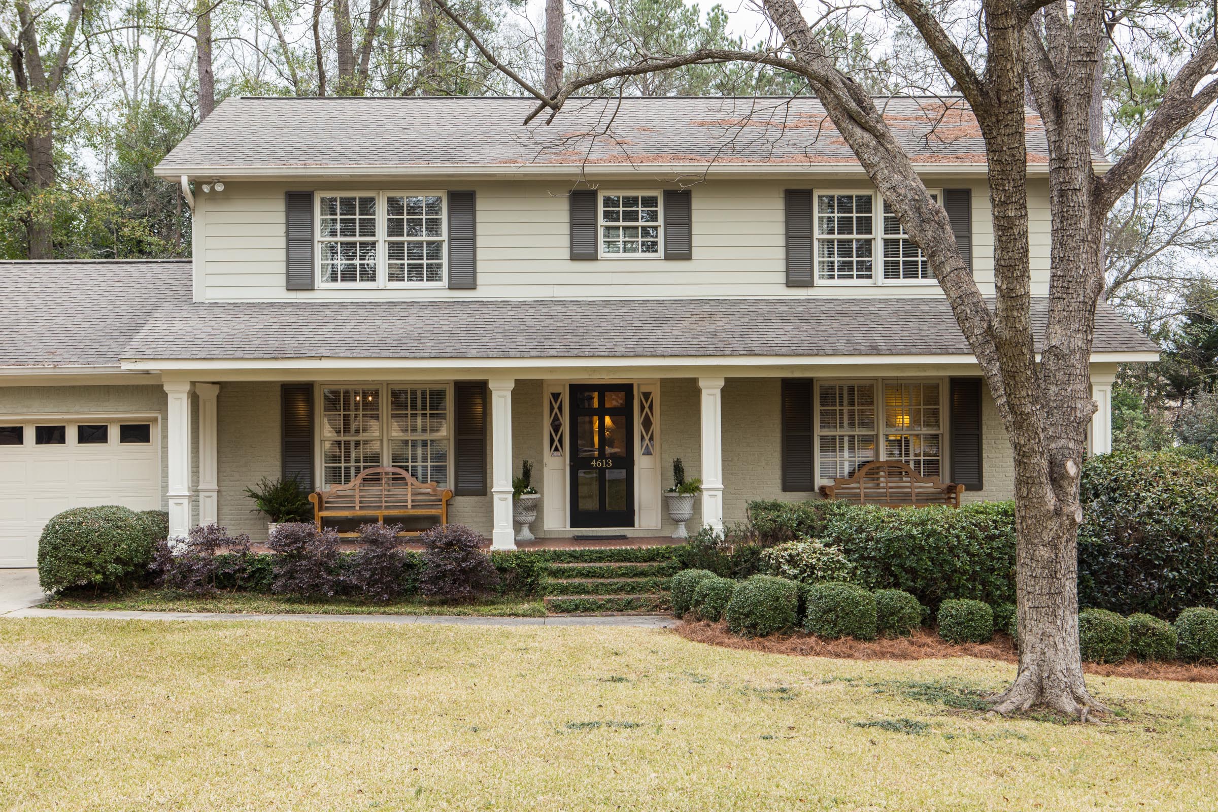 Carla and Michael Graf have enjoyed their exterior paint color scheme so much that they have not changed it since the purchase of their home in 2004. The palette of dark khaki, off white, and Charleston green is timeless.