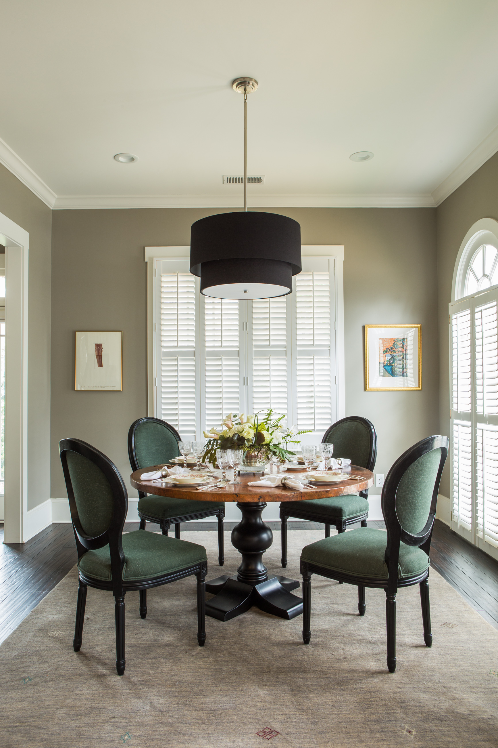 The dining room set for four rests in Sherwin-Williams ‘Intellectual Gray.’