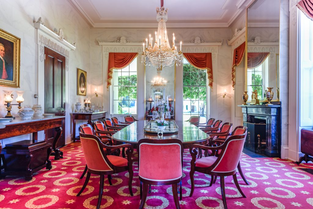 Millford’s dining room has a Manning-era Duncan Phyfe dining table, arm chairs, serving table, and wine cellarette. 
