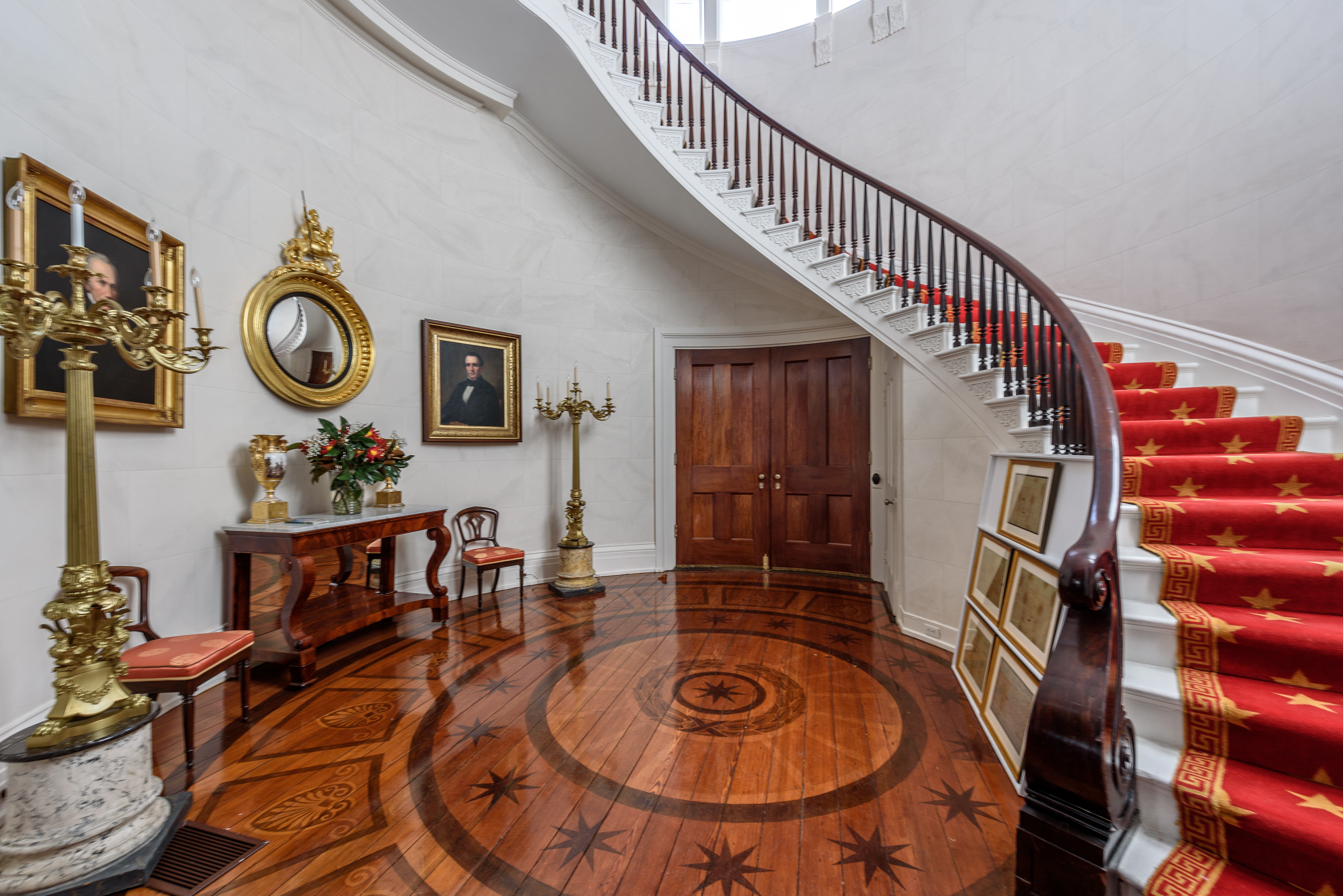 Millford’s back entrance opens to a sweeping spiral staircase and trompe l’oeil painted floor by Robert Jackson.