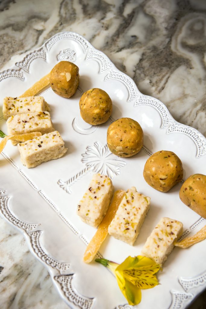 Barfi is a dense milk based sweet, derived from the Persian word for snow. The round balls are ladoo, made from gram flour, clarified butter, and sugar. Bhavna says that both are served at festive occasions. 
