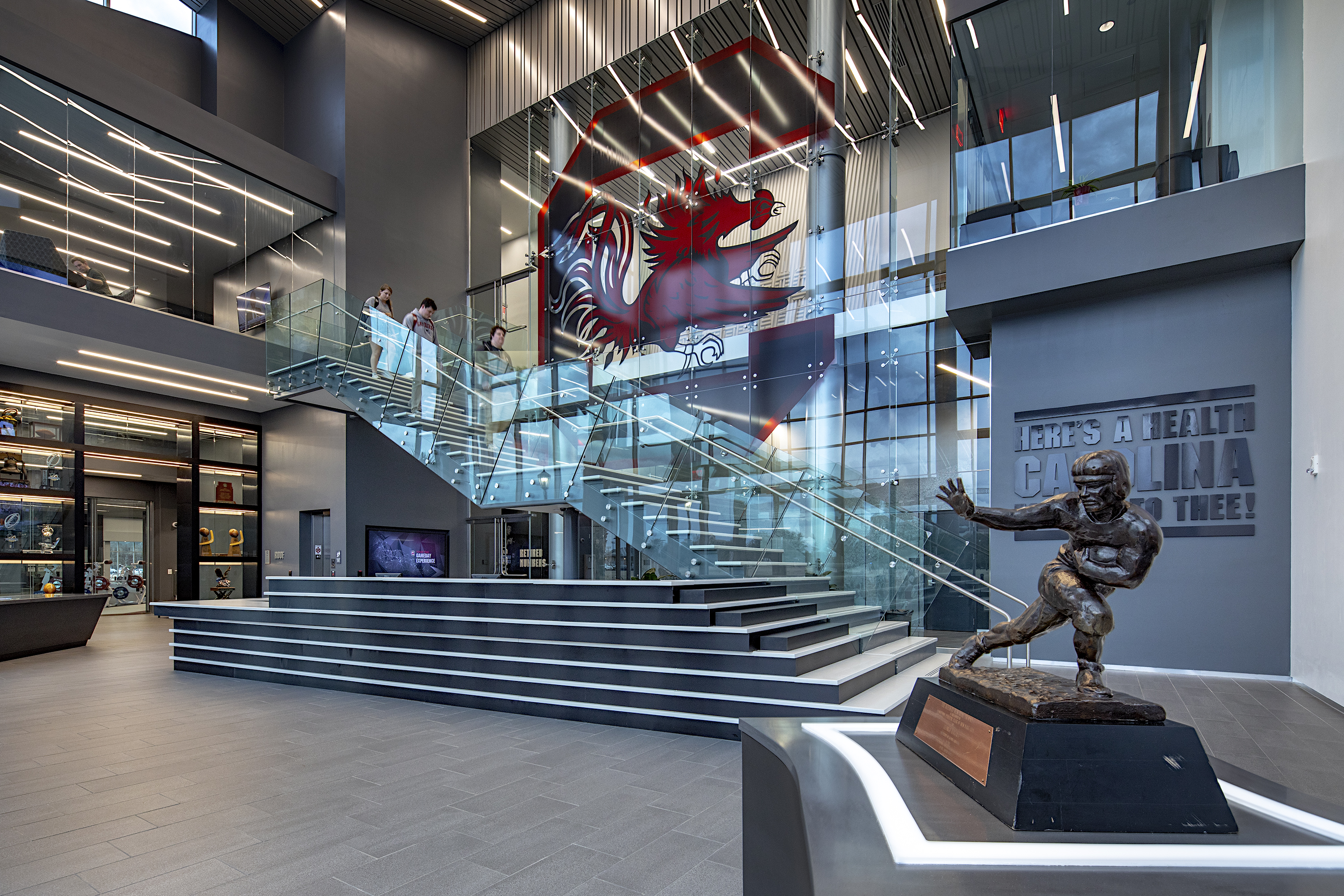 The $50 million Long Family Football Operations Center has 110,000 square 
feet of space to include a recruiting center, locker room, weight room, athletic training room, 
coaches’ offices, meeting rooms, dining room, and a players’ lounge. The new facility is the crown jewel of Gamecock football. 
George Rogers’ Heisman Trophy welcomes every athlete and visitor into the lobby.