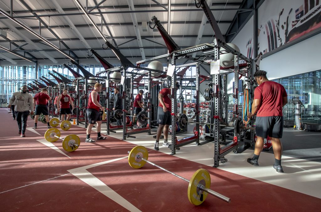 The second level of the weight room features a 4,000-square-foot cardiovascular mezzanine that overlooks the weight room and outdoor practice fields. Three garage doors line one side of the weight room, all of which open up to the Gamecocks’ outdoor practice fields and indoor practice facility.