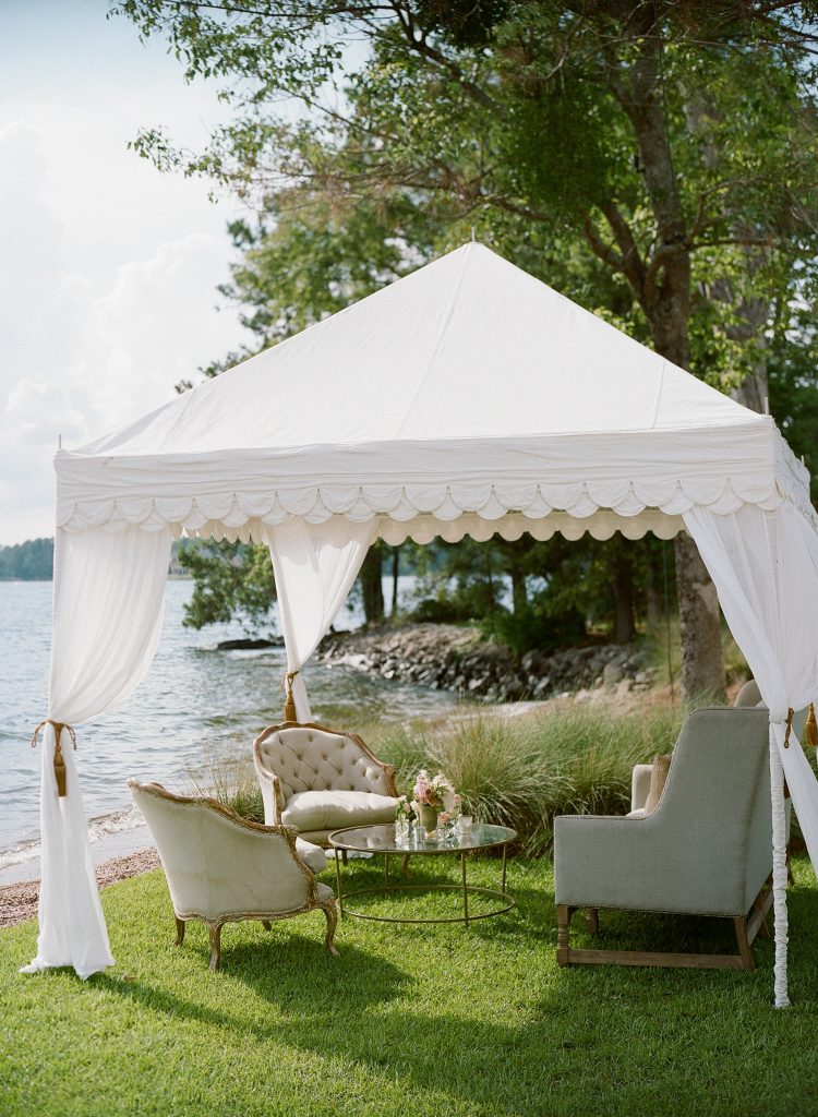 Erin and her mother, Mandy, enlisted the help of Megan Warren to lead the wedding planning efforts. Outdoor seating is classically and tastefully tented lakeside. 