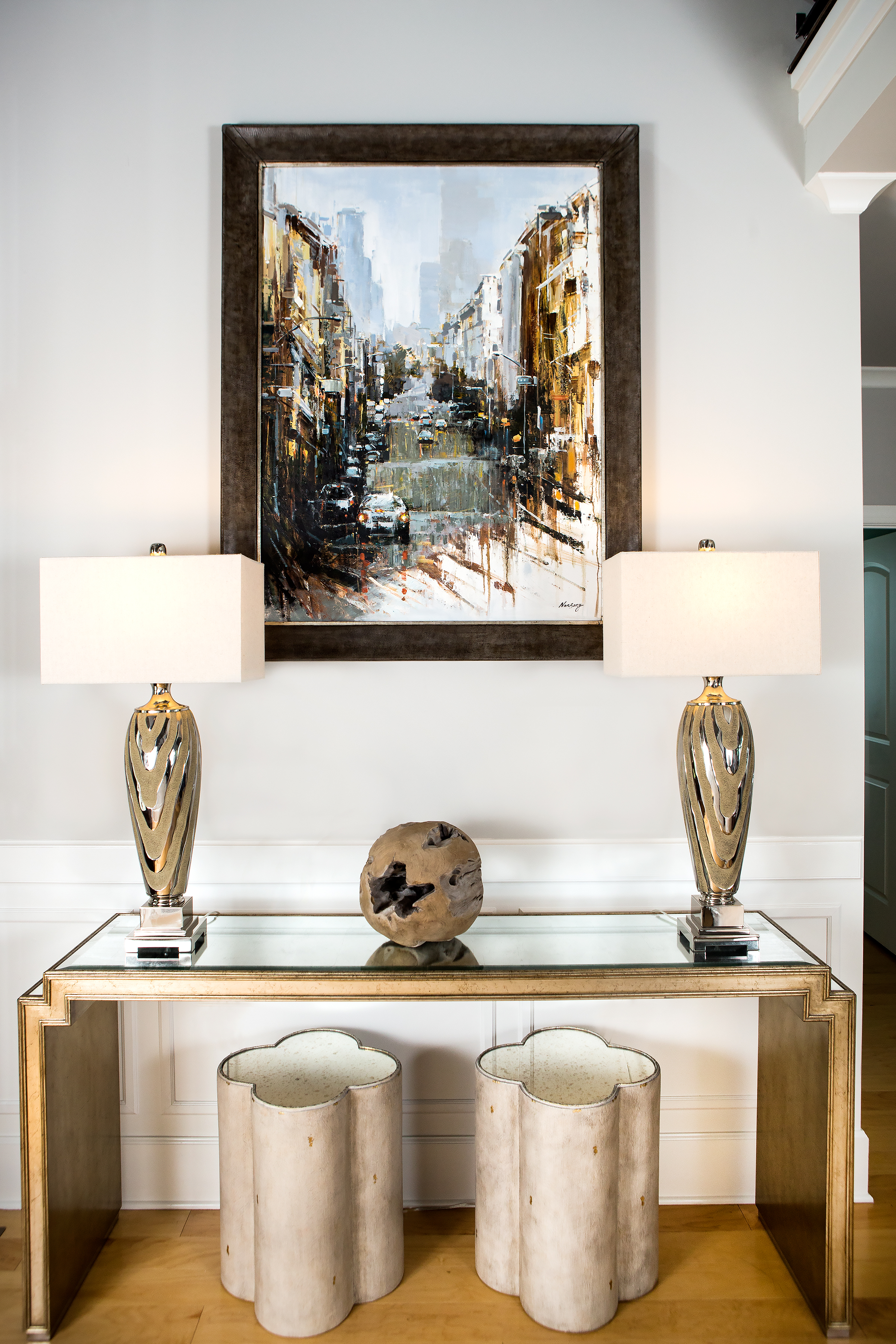  The handsome entrance hall is painted Repose Gray by Sherwin Williams. An avid art collector, Paul purchased the painting of San Francisco by artist NanSong from House of Frames. 