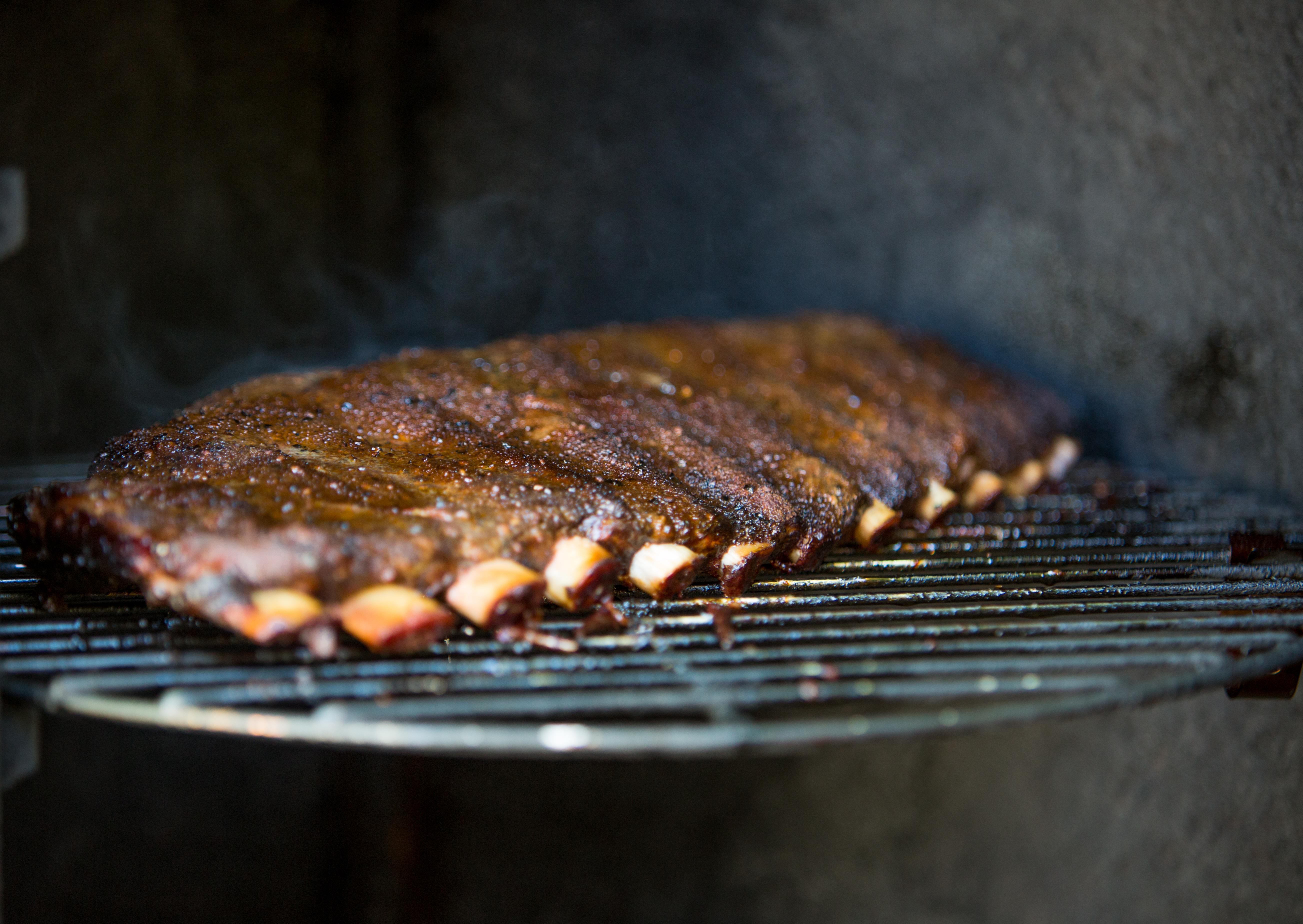 Let the ribs cook for 90 minutes without opening the smoker — if you're lookin', you ain't cookin'!