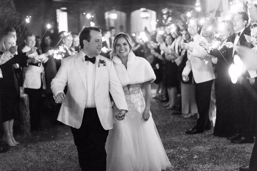 Ali and Taylor Brown were married at Mountain Top Golf and Lake Club in Cashiers, North Carolina. The bride chose to leave in her gorgeous wedding gown with a white fur cape surrounded by family and friends waving sparklers. They made their way for a night at The Old Edwards Inn before leaving for a two-week honeymoon in Lake Como and Tuscany. Photography by Kickstand Studio.
