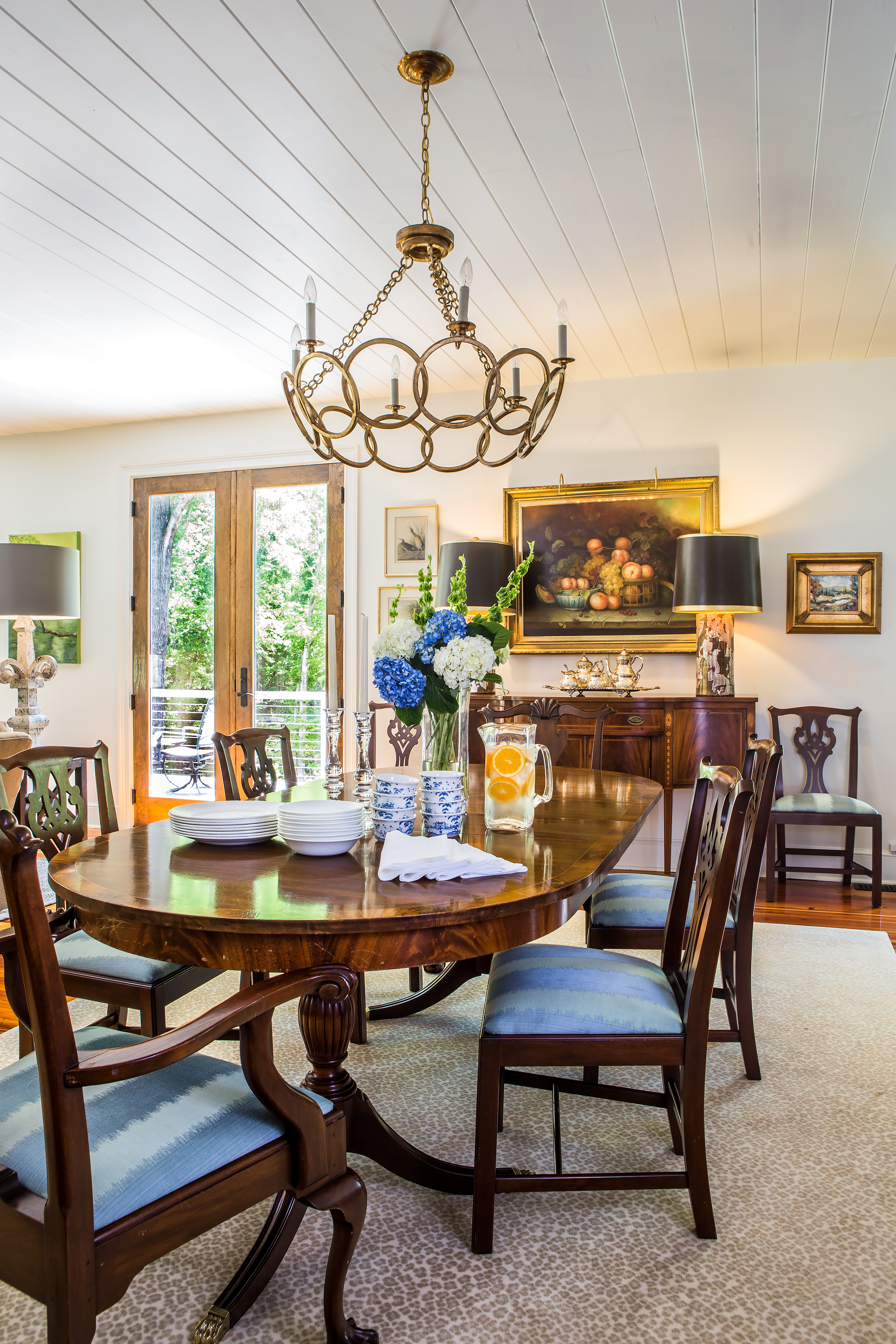 An original wet bar was transformed into the central dining area. An eclectic mix, highlighted with sentimental family pieces, artwork, and lamps, are favorites from Juleah’s mother-in-law, Martha Blatt. 