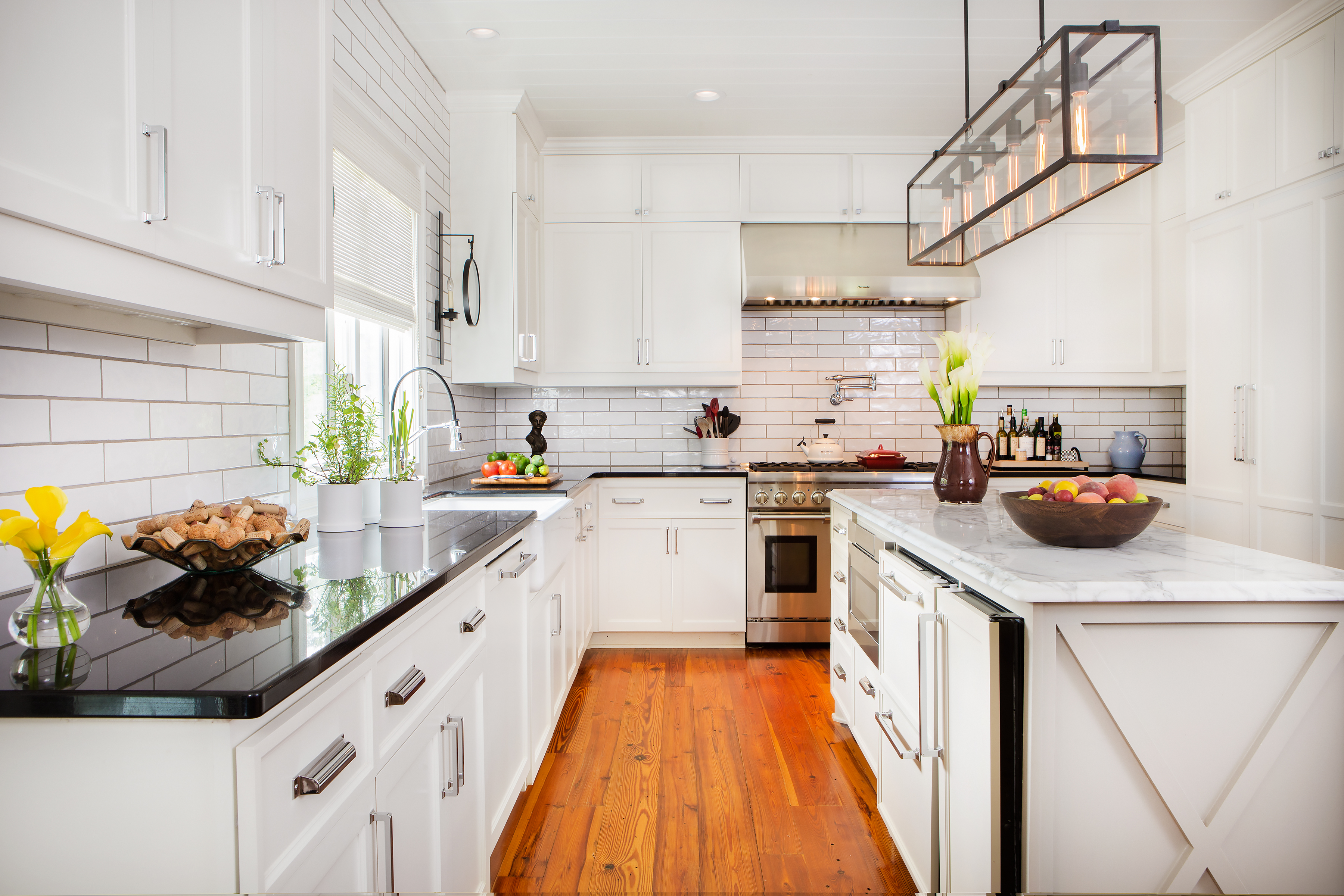 The kitchen area, open to the dining room and living area, shows the most significant changes. The symmetrical plan of white cabinets, chrome fixtures, and crisp lines make it Juleah’s favorite room in the house. 