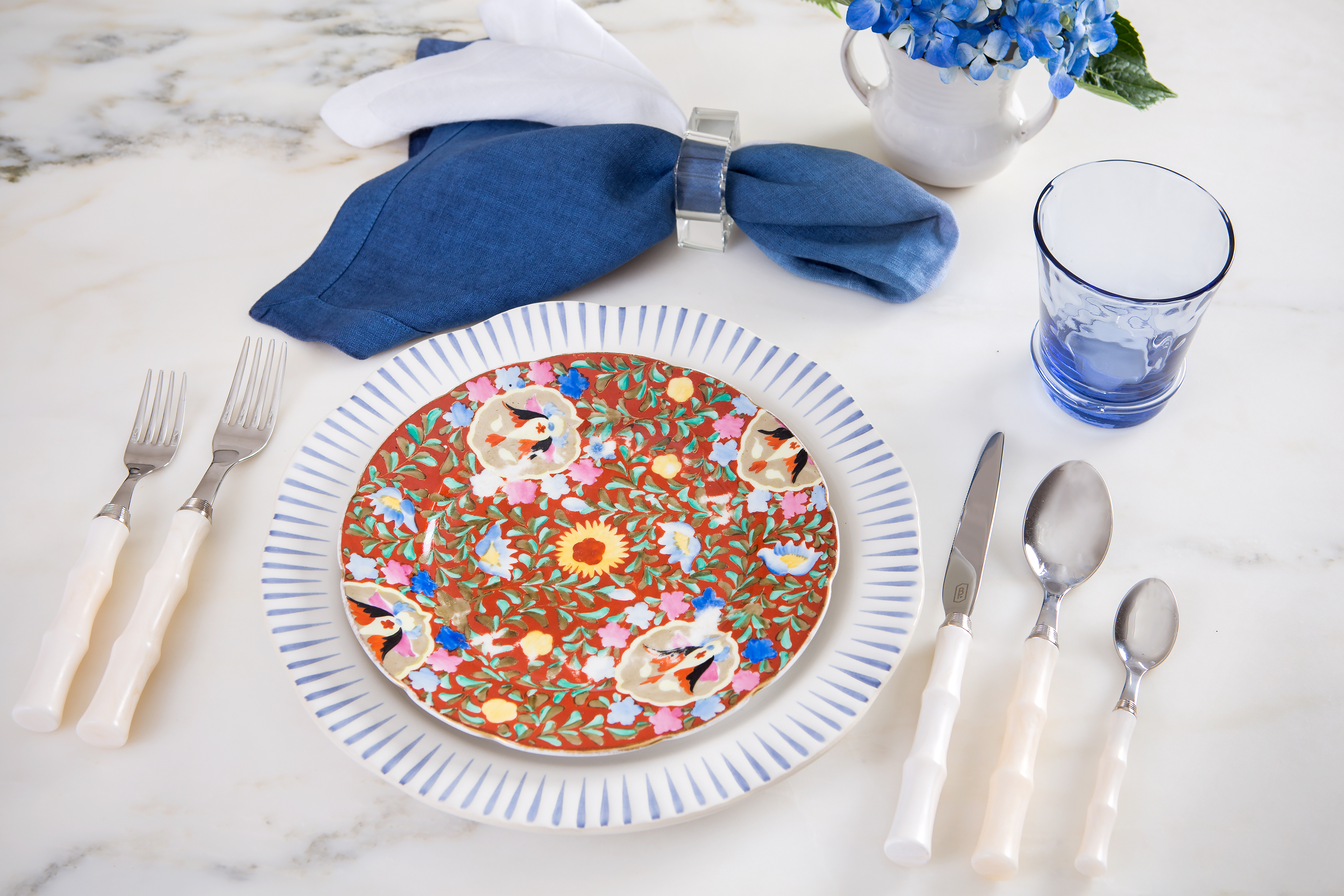 Give antique heirloom salad plates a fresh feel for a “rise and shine” brunch! Pair with Juliska Sitio Stripe Indigo plate, Carine blue tumbler, and napkin for a crisp blue and white theme. Blue Pheasant Montecito Ivory Acrylic place 
setting adds flair to any grouping, non(e)such.
