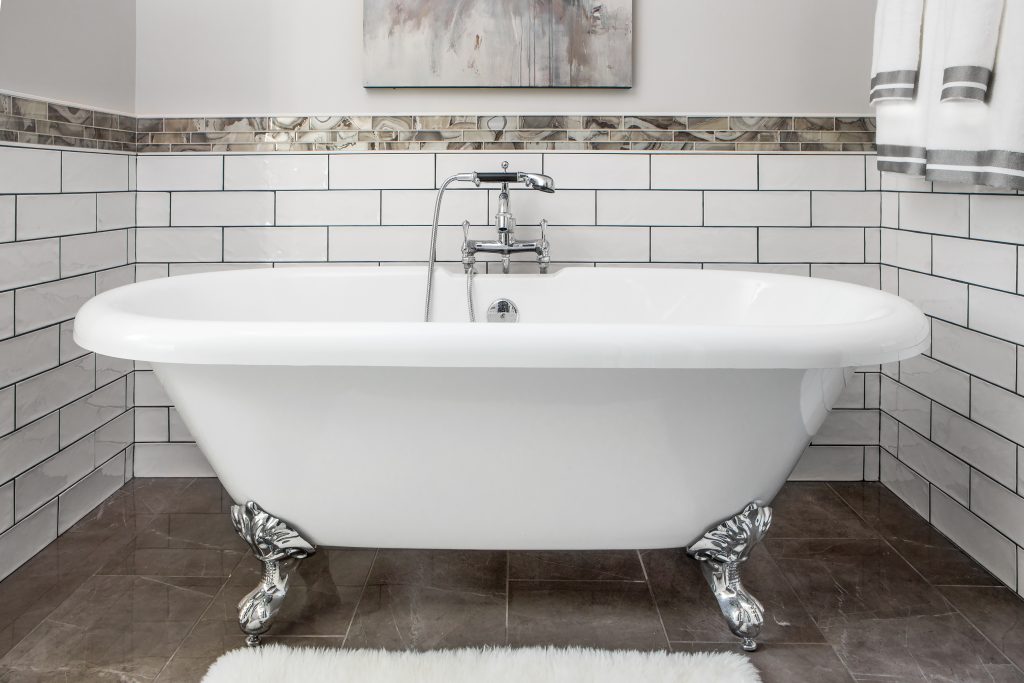 The clawfoot bathtub was 16-year-old Blake Helms’ first choice when she made selections for  her bathroom. The addition of black grout with the  white subway tile makes a bold contrast and adds an industrial vibe.