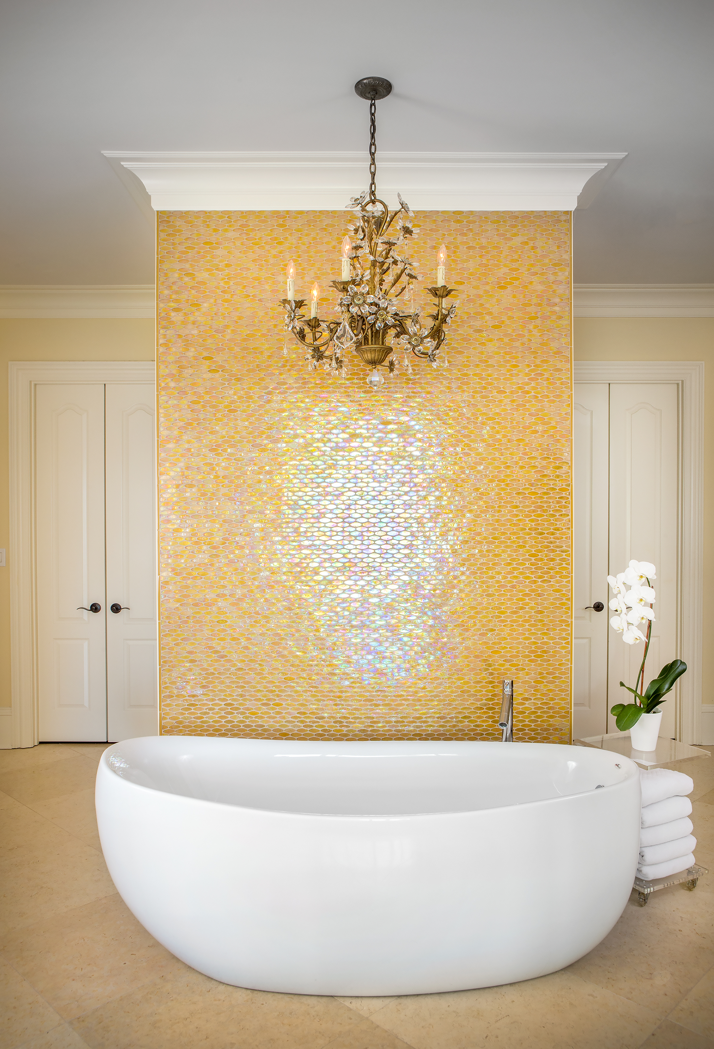 Esther Greenberg at the Tile Center assisted Marcie Baker with her selection of oval glass mosaics with pearl essences to coordinate with the freestanding bathtub in her luxurious, dramatic bathroom.
