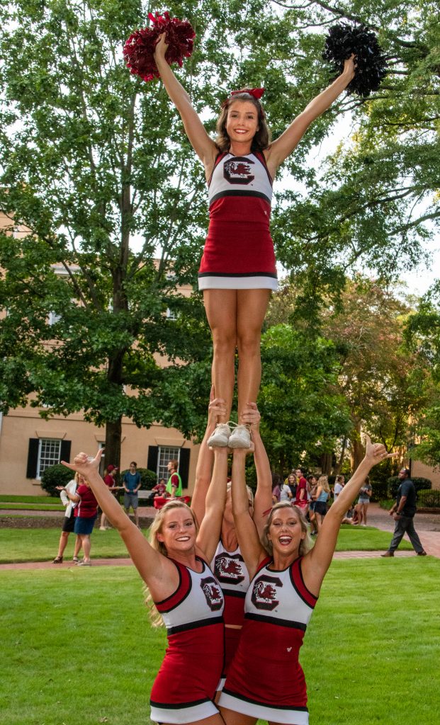 Allie Gallagher is also a USC flyer held up by Jessica Smith, Hannah Norman, and Sidney Tilton.