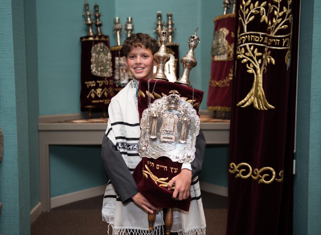 Following his Torah reading, Sam presents the Torah to the congregation filled with family and friends before walking the Torah around the sanctuary and greeting everyone in attendance. 
