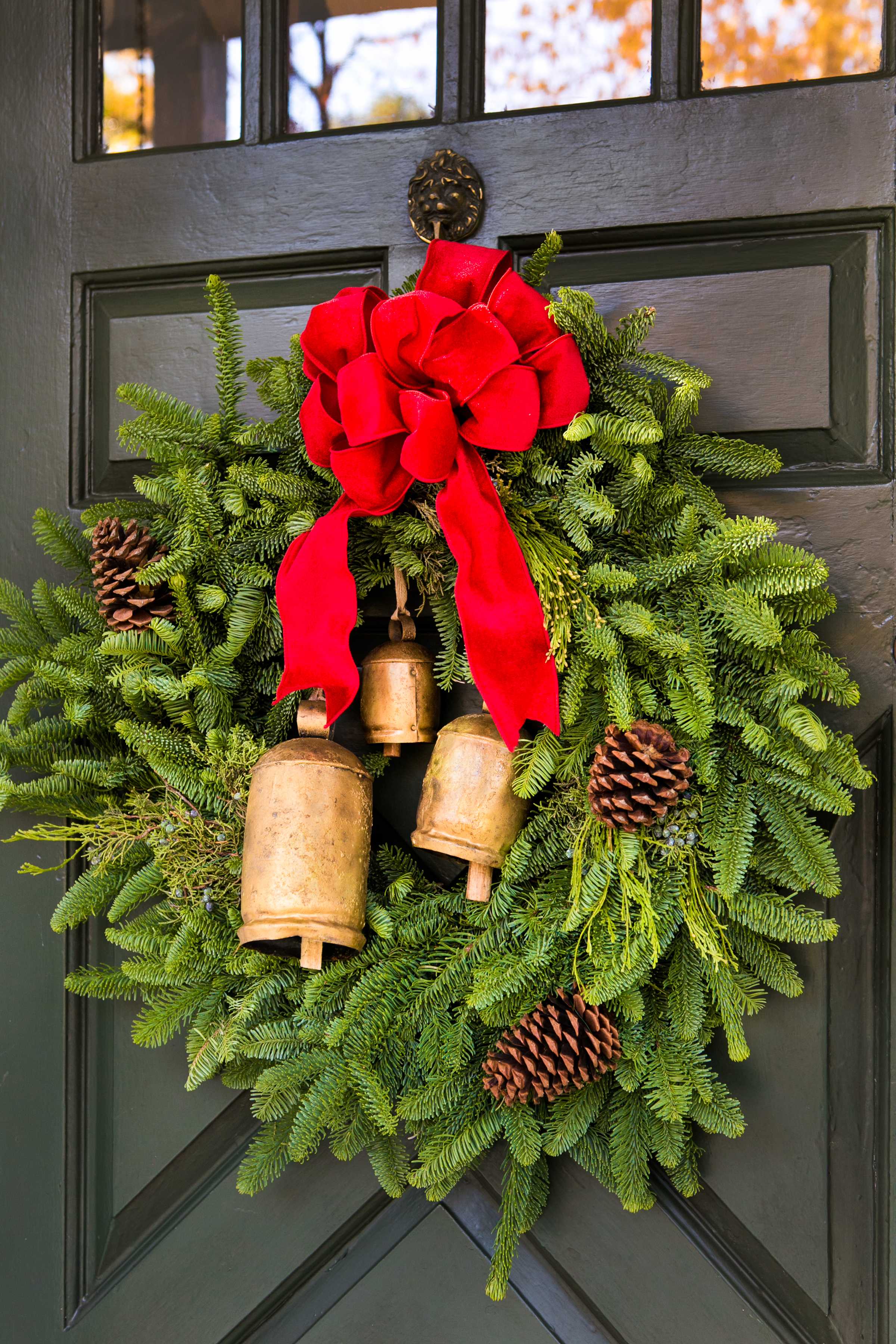 A welcome Christmas jingle, jingle for all who enter, this charming fresh Fraser fir wreath has vintage brass bells!