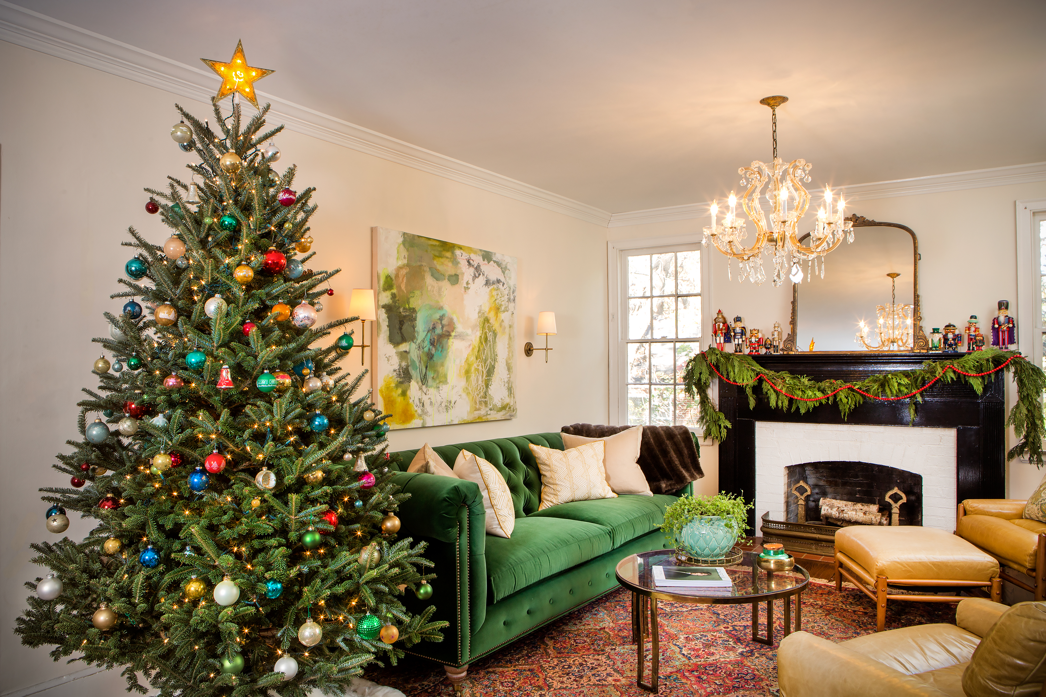 The Rourkes’ cottage living room breathes the scent of Christmas with a fresh cut Fraser fir from a local farm. The mantel is decorated with Leyland cypress garland woven with red beaded swags and nutcrackers from an estate sale. A glittering chandelier was a gift from Jessica’s mother, and a painting by local artist Miles Purvis Daniel was commissioned for the charming and sophisticated space.
