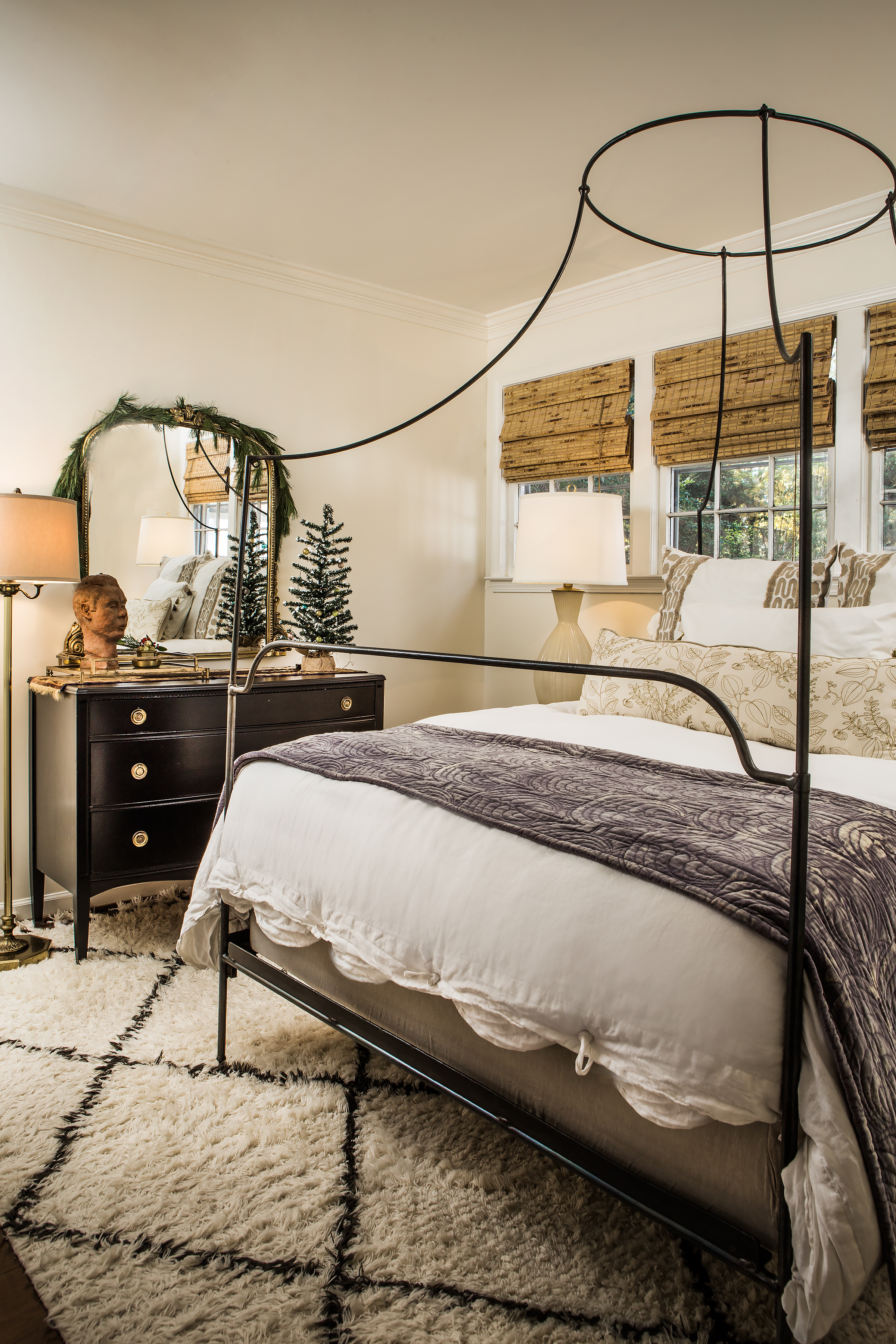 The focal point of the couple’s master suite is an Anthropologie bed with a contemporary canopy and custom pillows. Simple fresh greens accent the tasteful, understated space.