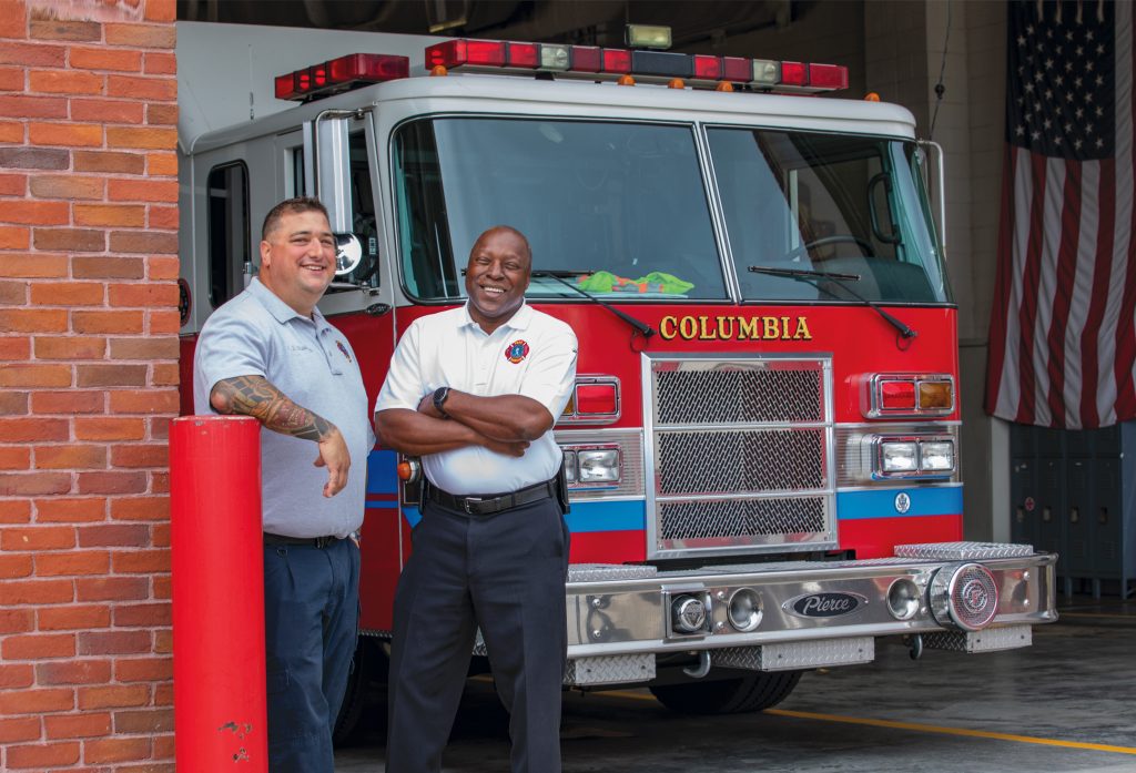 Moose Moskaitis and Columbia Richland Fire Chief Aubrey D. Jenkins pose for a photo at department headquarters.
