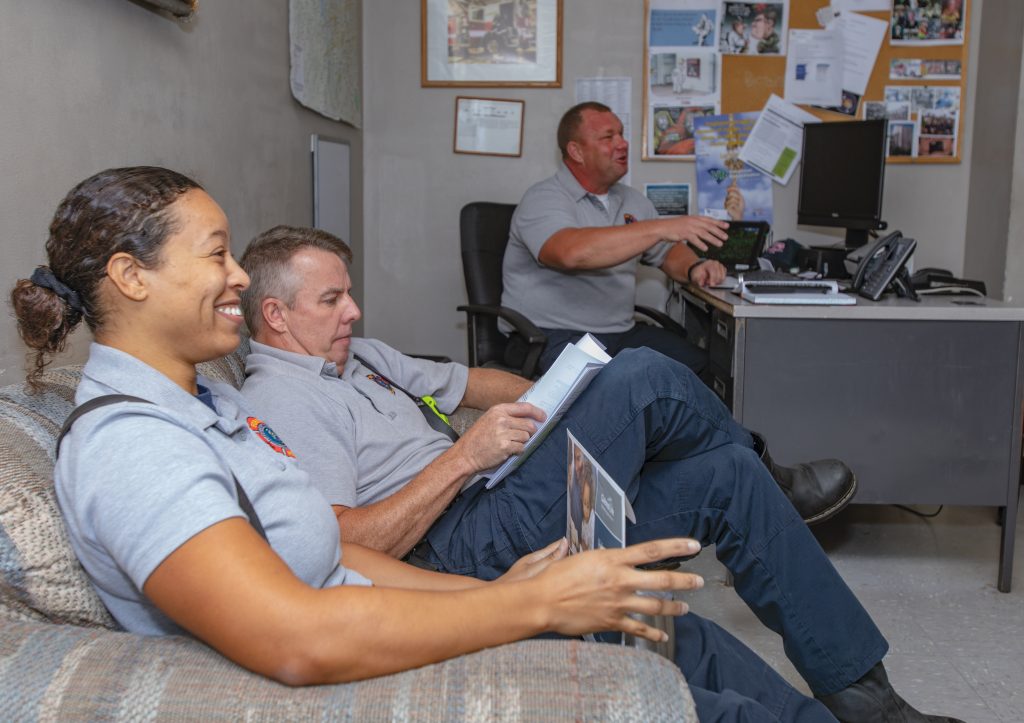 Firefighters gather in the captain’s office at Station 1. 
Over the course of their work day, fire crews have to balance meetings, training sessions, and station chores in addition to answering calls for service.
