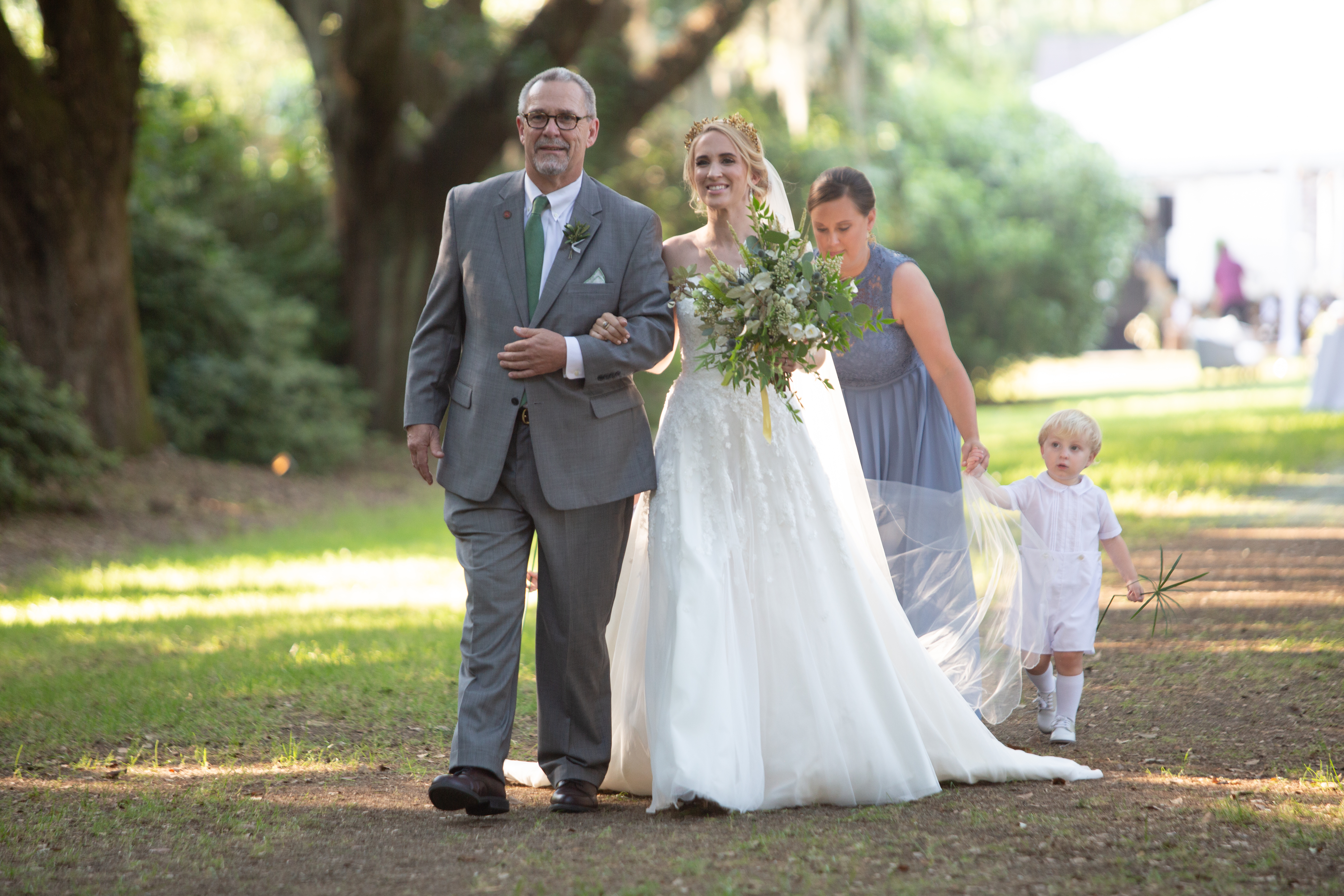 Lauren McFadden was escorted down the aisle by her father, Mac McFadden, while the bride’s sister, Mary Mac Wilson, attended to Lauren’s veil with the help of Lauren’s two nephews, Harry Wilson and Bennett McFadden. 
