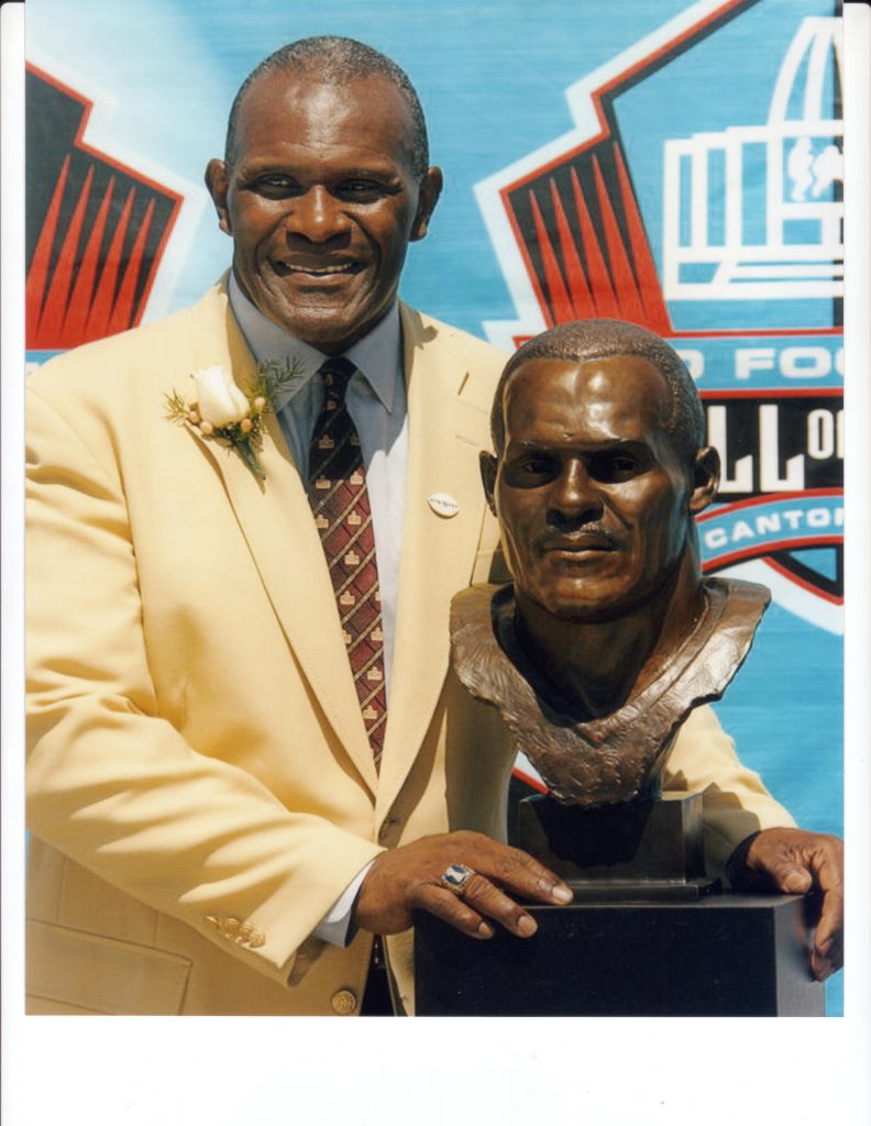 Harry stands with his bust on the day he was finally inducted into the Pro Football Hall of Fame in August 2006, in Canton, Ohio.