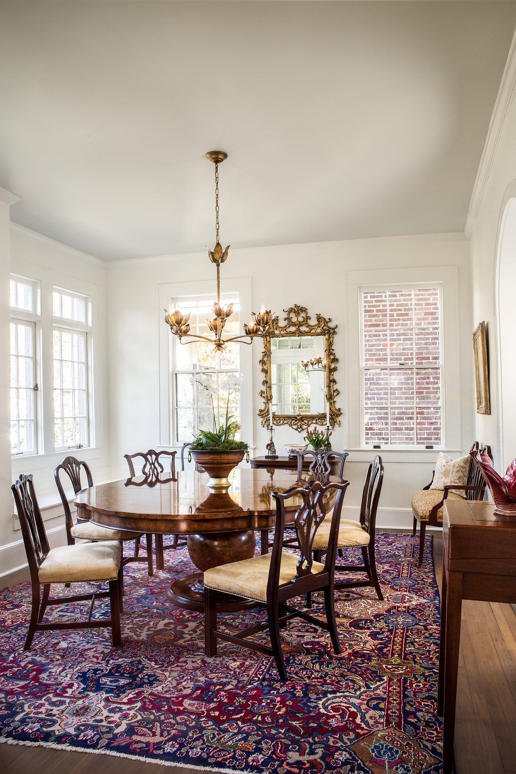 The dining room, located on the front of the house, was kept in its original state to showcase the authentic casement windows and hardware with old hand-blown glass. 

