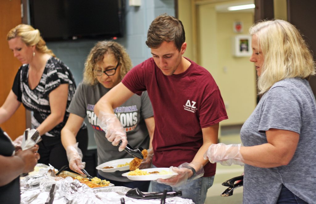 Tami Mistretta, Mariah Armstrong, Brady Buffum, and Lisa Anderson serve food during one of Growing Home Southeast’s “Strengthening Families Programs.”