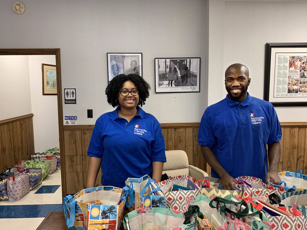 Communities in Schools site coordinators Tabitha and Brad prepare care packages for 65 Resilient Richland families.