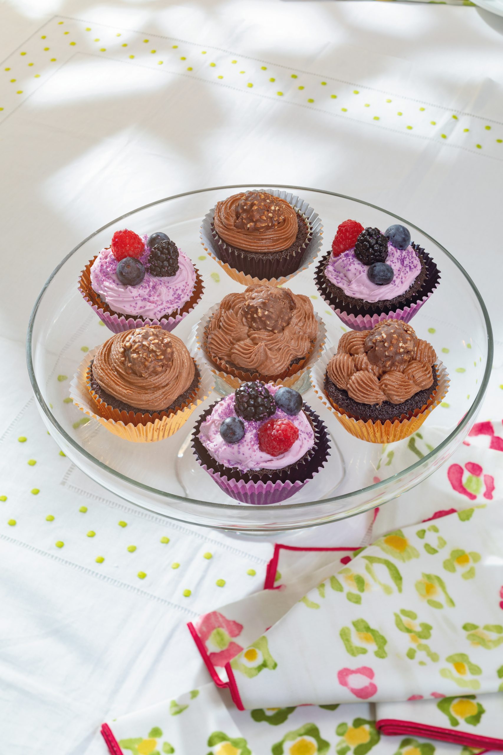 Chocolate Hazelnut Cupcakes can be topped with chocolate hazelnut frosting or cream cheese berry frosting. Courtesy of non(e)such: Karen Lee Ballard Hem Topper tablecloth in lime with floral Ballard napkins. 