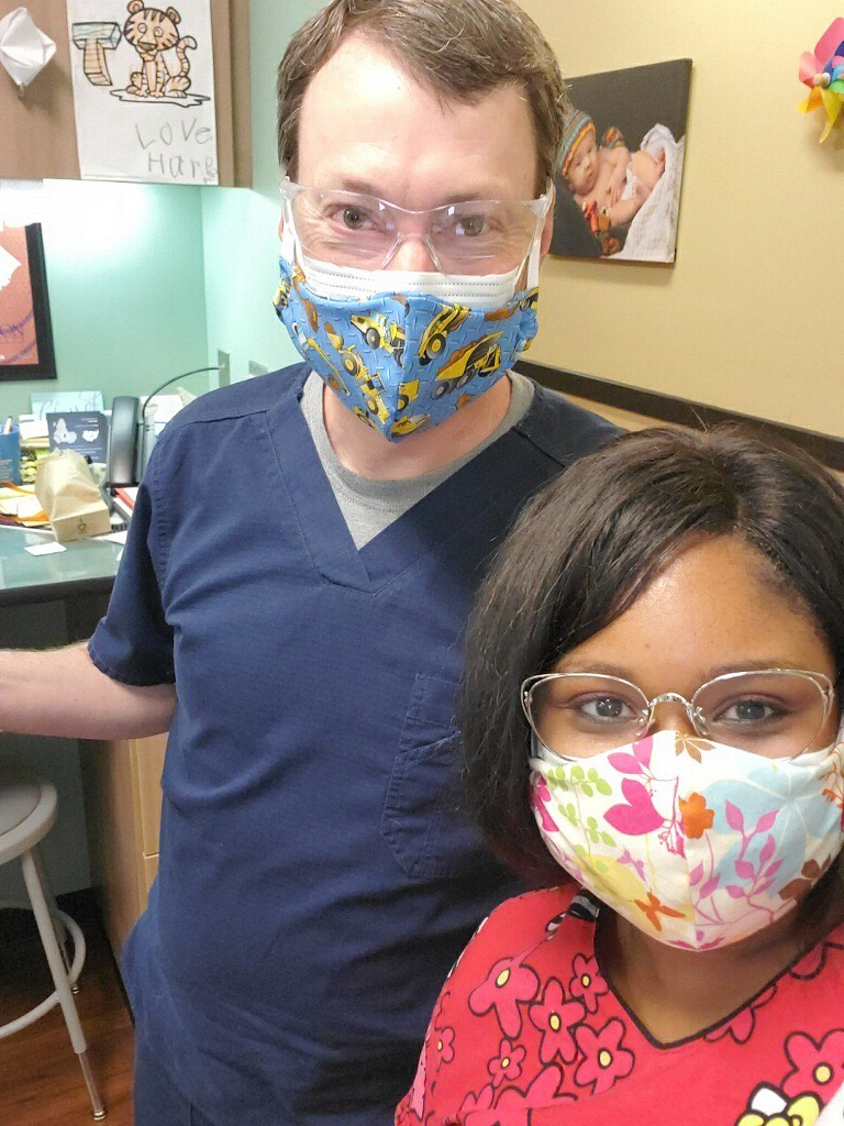Cotessa Jones, NA, MA2, and Barry Cabiness, MD, Palmetto Pediatrics, wear masks that were sewn and donated by Shannon Johnson and her daughter, Mary Wyatt Johnson.
