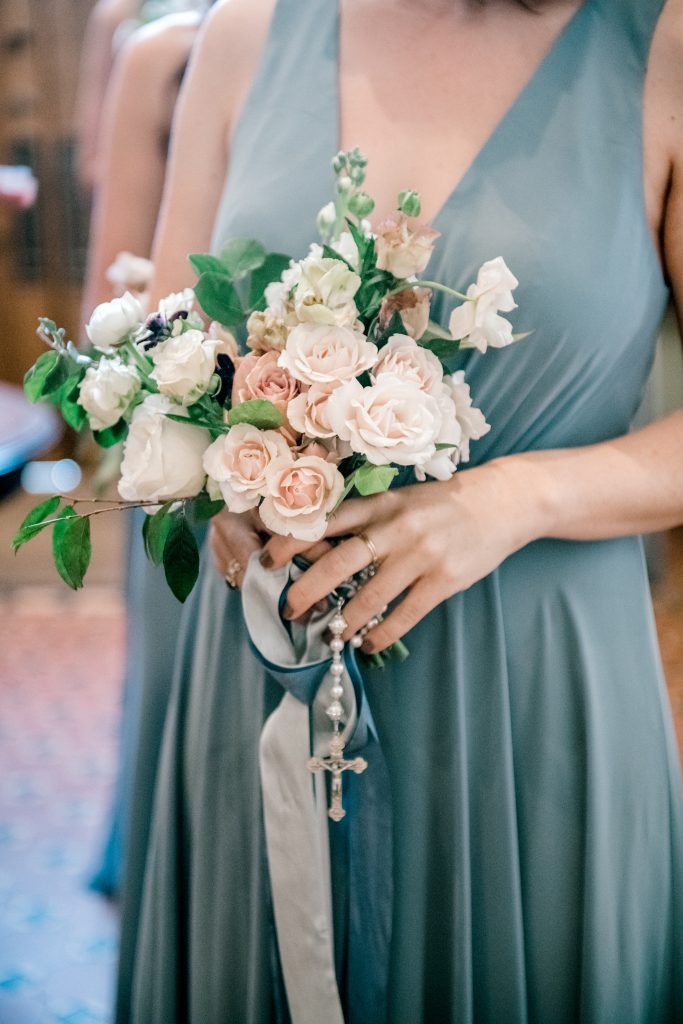 The bridesmaids carried blush bouquets, which were the perfect complement to their long Jenny Yoo dresses in dusty blue.