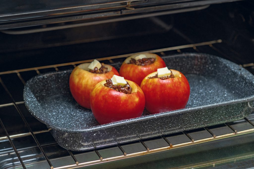 Before baking, top the stuffed apple with a dot of butter, then place the apples in a pan with about 1 inch of water.