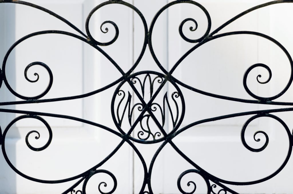 Intricate wrought-iron features are a striking component of the grounds. The center design includes the initials for William W. Wannamaker, Jr. 