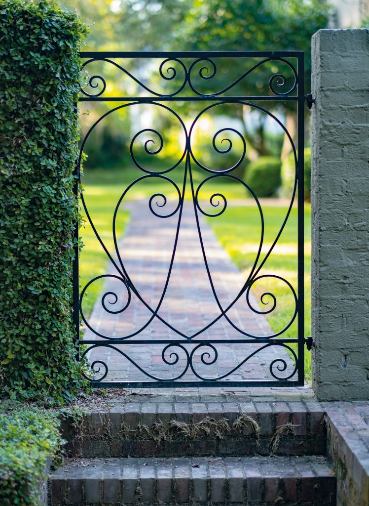 Spanish moss adds an allure throughout the grounds, and the wrought-iron gate featuring a heart shape symbolizes the love the Sabalises have for their home.