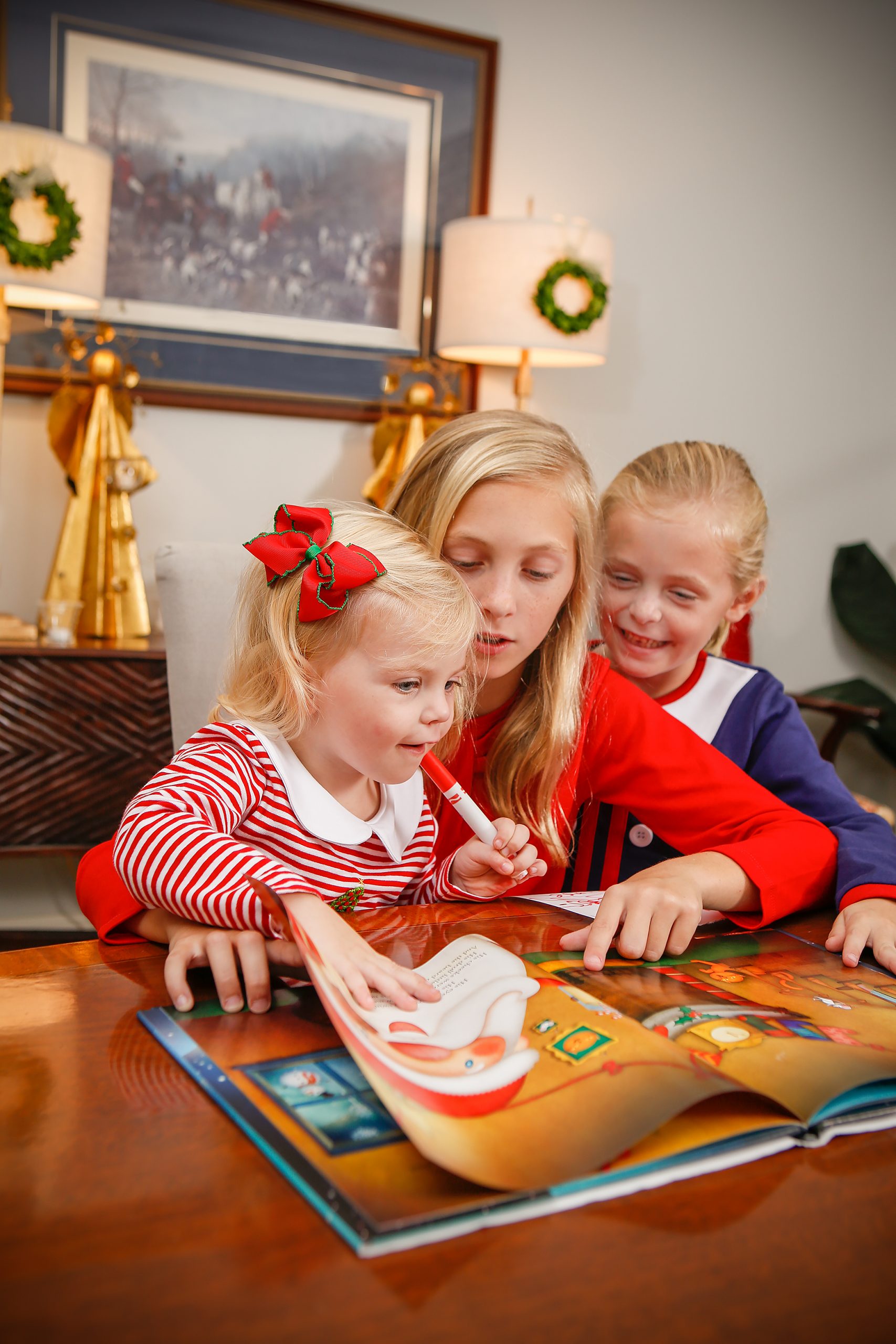 Reading The Night Before Christmas is a family tradition for the Barron family. Two-year-old Collins listens as 11-year-old Eliza and 7-year-old Charlie take turns telling the story of Santa’s visit on Christmas Eve.  