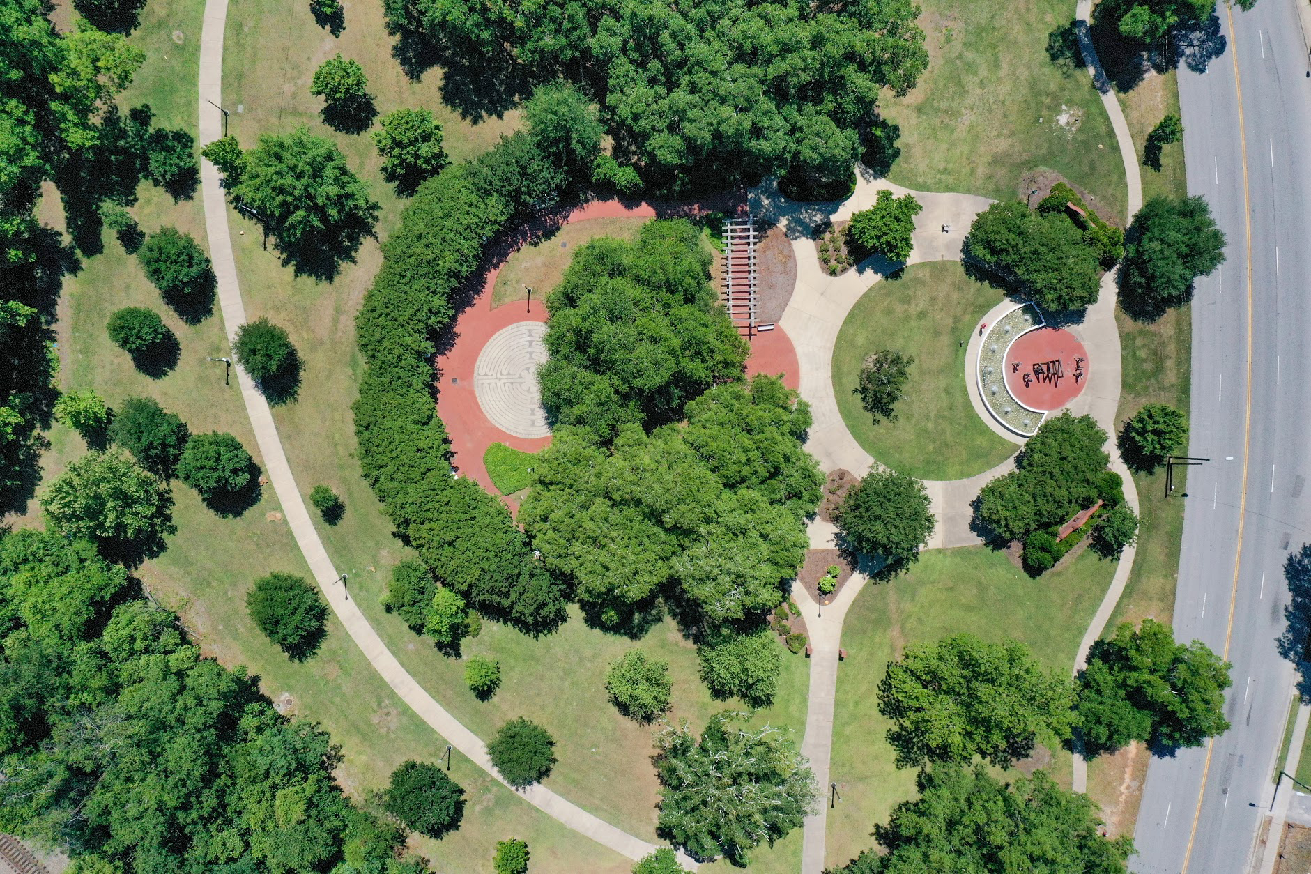 The curvilinear paths, formal gardens, and stately trees define Maxcy Gregg Park along Blossom Street. 