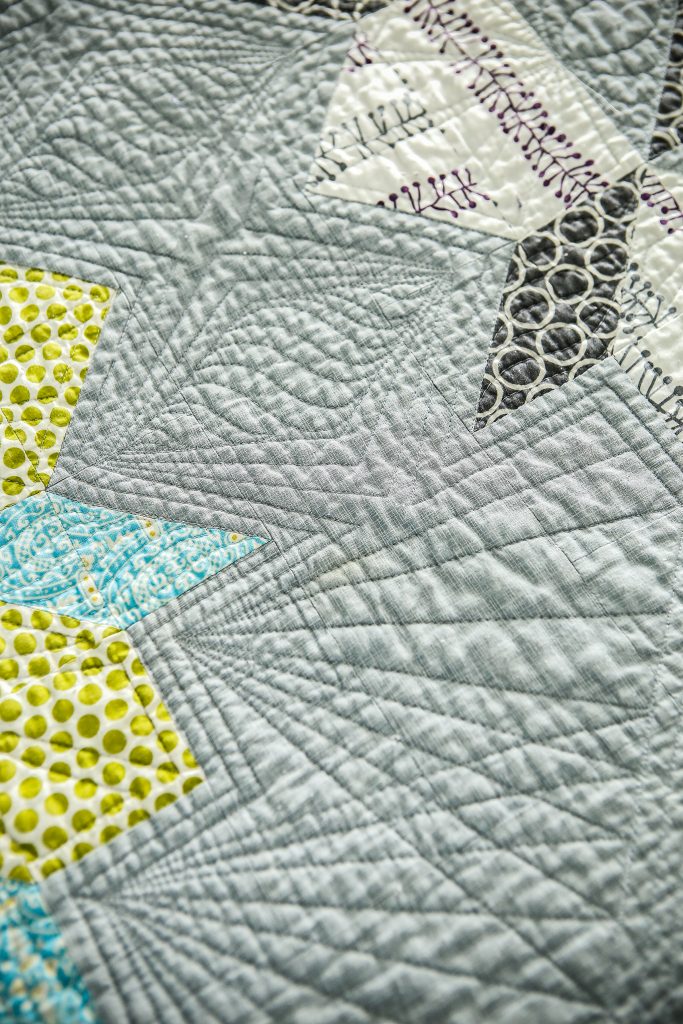 Geometric quilting pattern pieced by Kristy and sewn by Angela Walters.