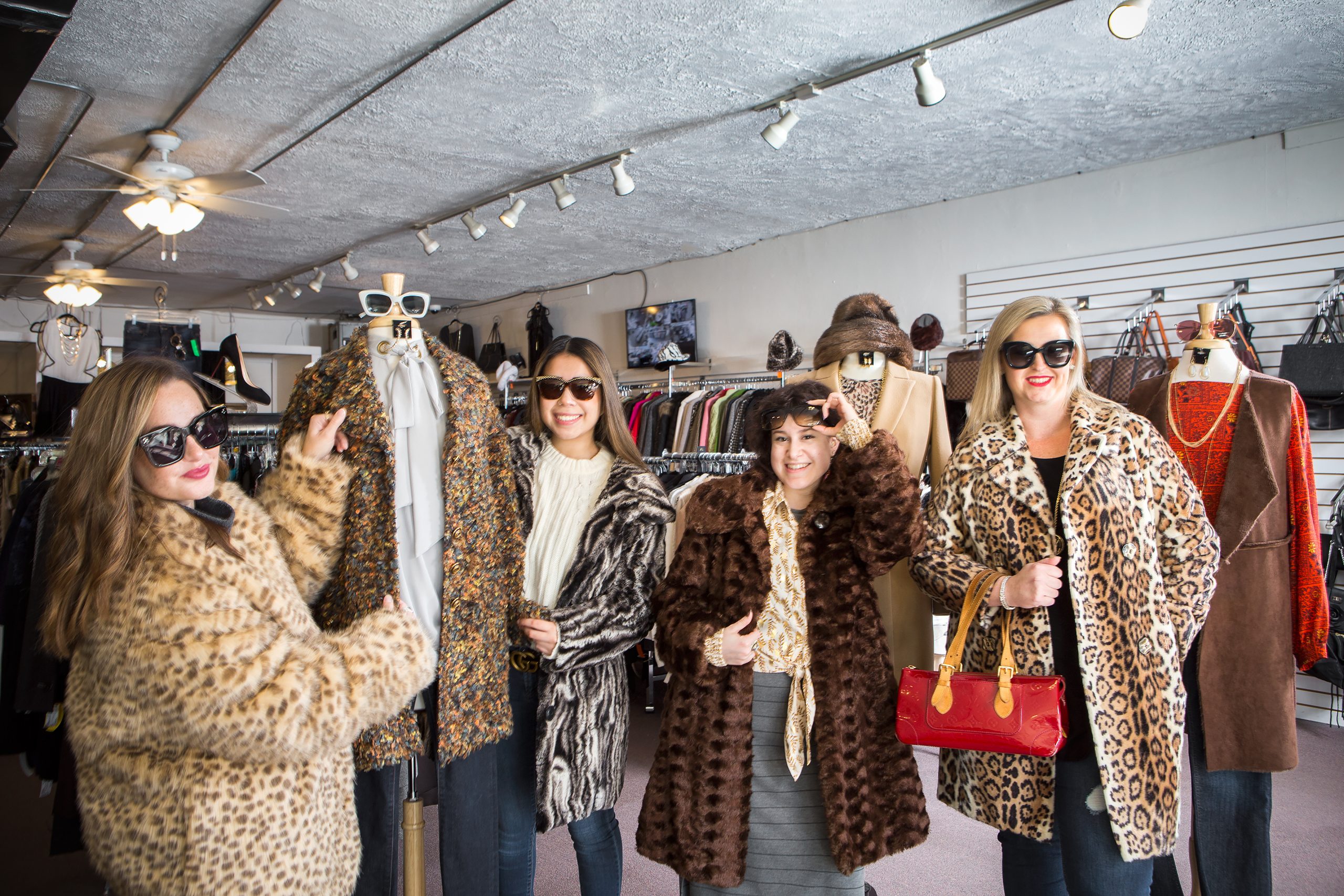 Audrey Delk, Ana Hait, Charlotte Wallace, and owner Heather Burns are ready for shoppers this winter in fashionable furs at Revente, voted Best Consignment Clothing Store.