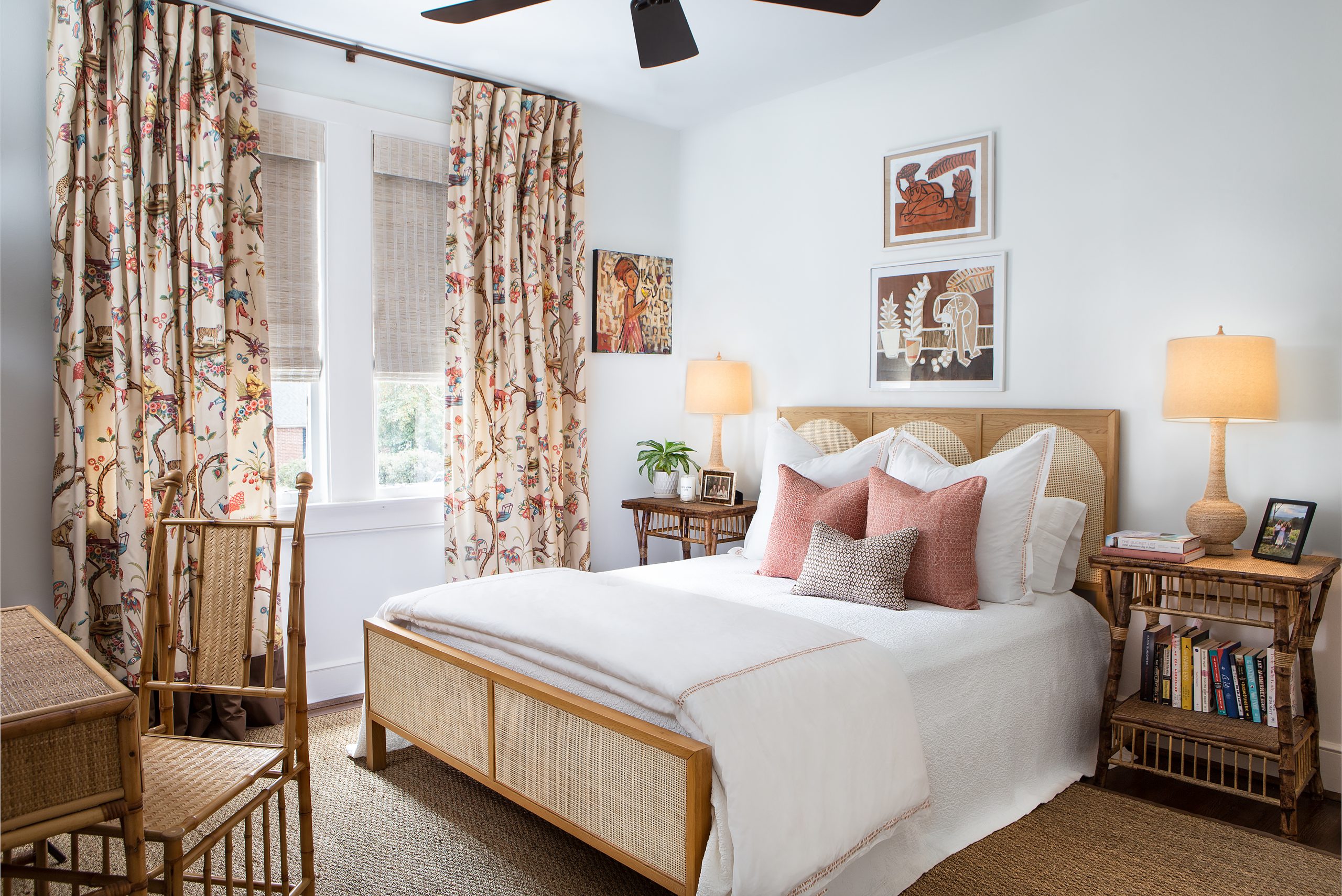 The guest room has an overall natural appeal with bamboo, grass, and cane. The focal point is the timeless Scalamandre chinoiserie drapes, repurposed from Mary Bond’s parents’ home. A painting by local artist Page Morris on the right captures the colors and ambiance perfectly. 
