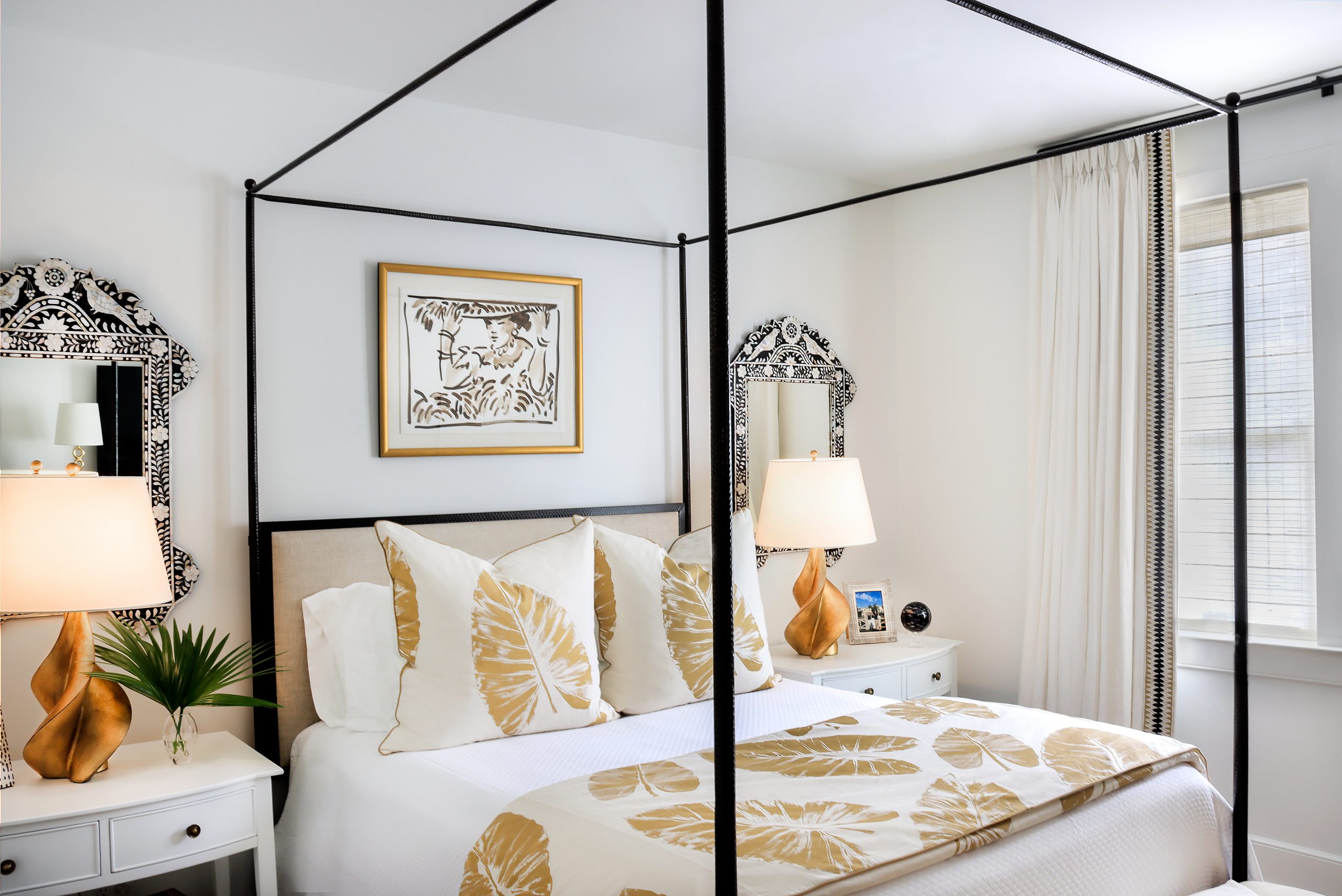 Mary Bond’s bedroom is peaceful and exotic, with a hammered wrought iron bed dressed with white coverlet accented by Rose Cumming banana leaf fabric. Mary Bond admits to an obsession for palms and animal prints — a signature throughout her eclectic home.
