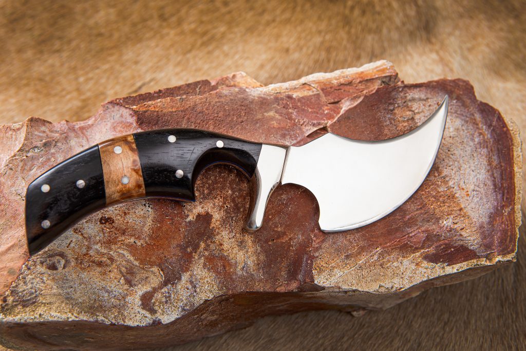 This custom skinner, designed by Robert for large game, takes many hours to assemble. The handle is black ebony and maple burl. 