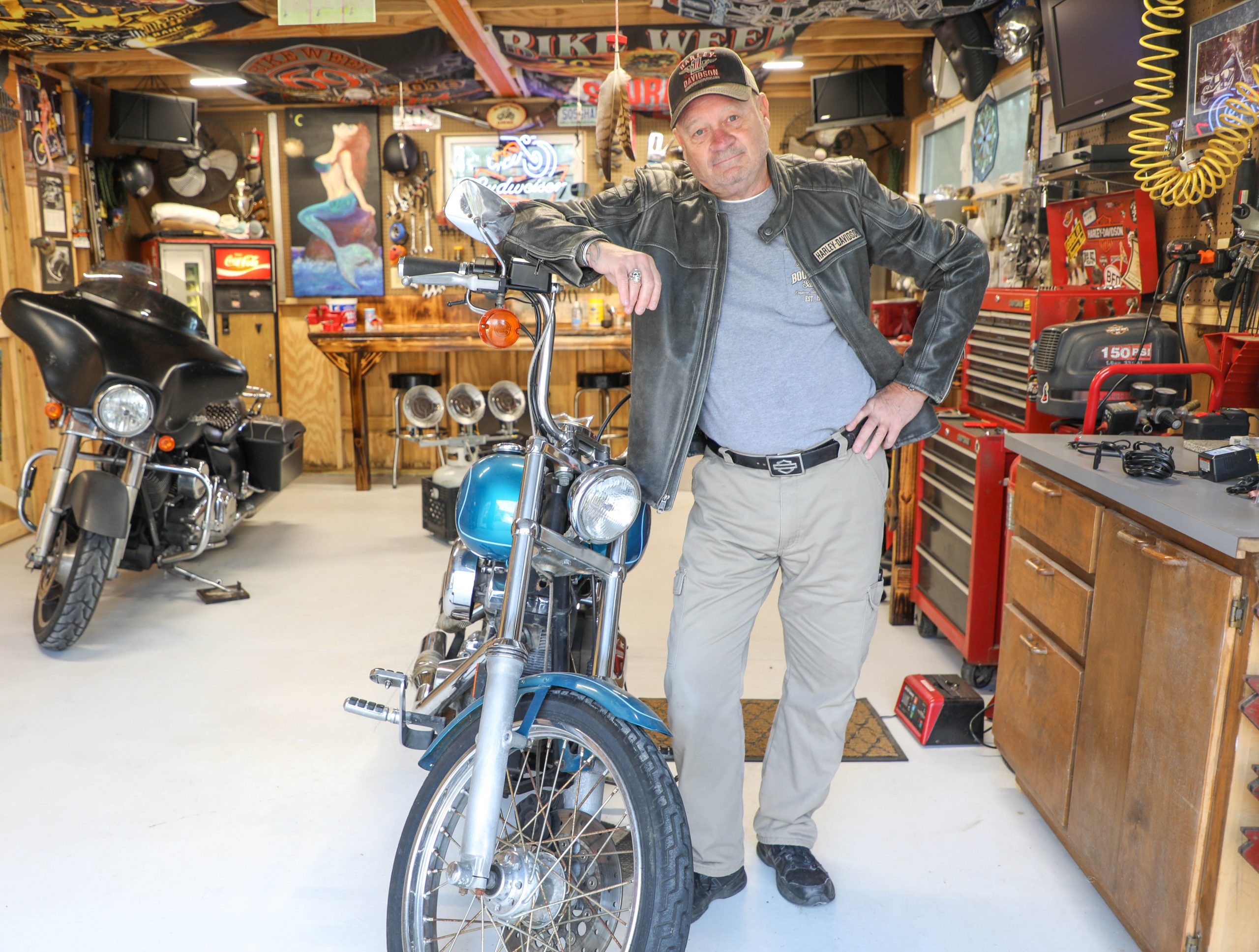 Phil Sawyer, Jr. in “Philo’s Garage,” home to his two Harleys and all things Sturgis Motorcycle Rally.