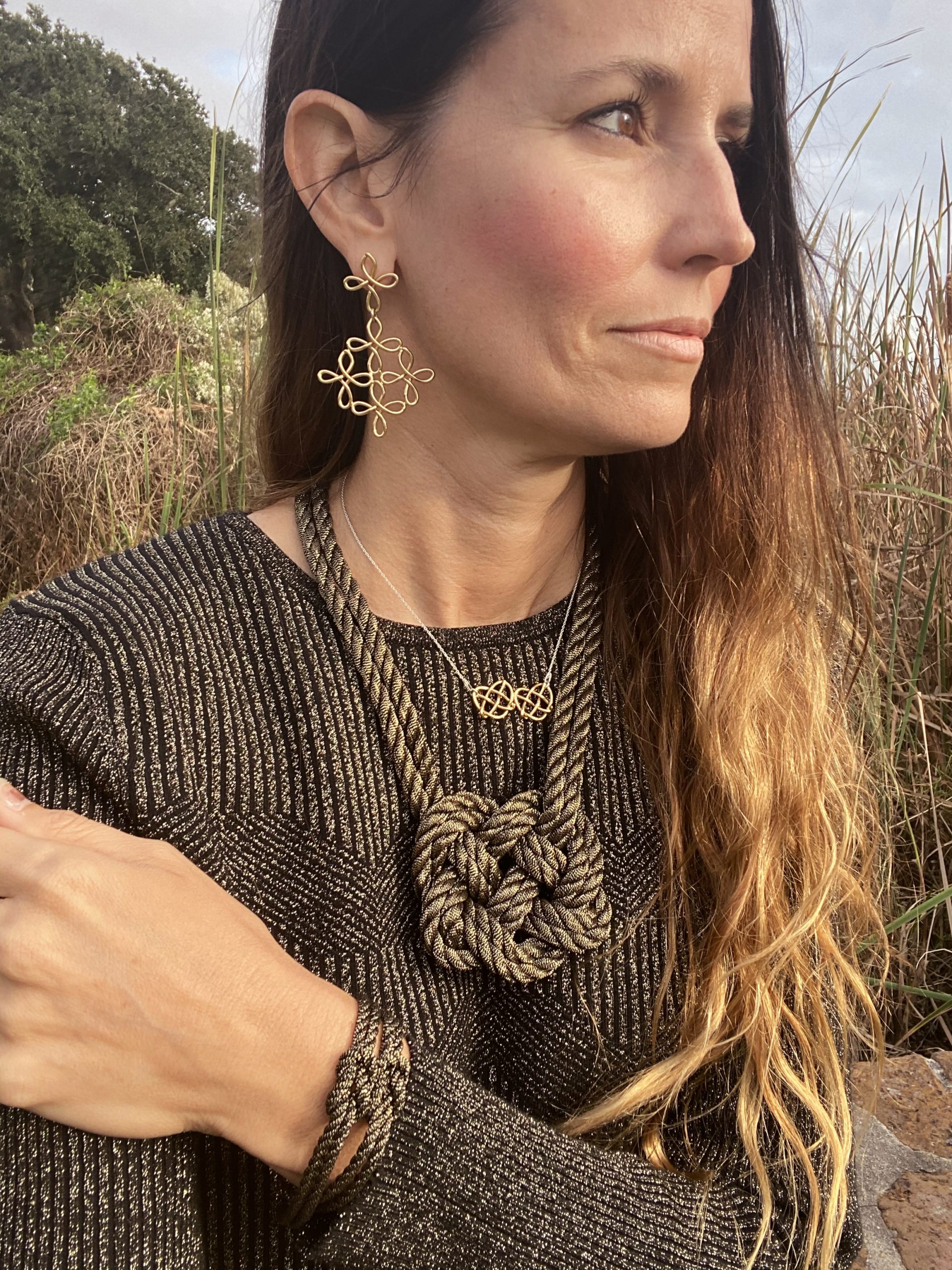 Inspired by a knot seen in The Ashley Book of Knots, Mary Kent Hearon began experimenting with rope to make jewelry. She eventually created her signature piece of jewelry, The Heart Knot, also the name of her business. Her necklace is The Double Heart Knot in Black & Gold. 