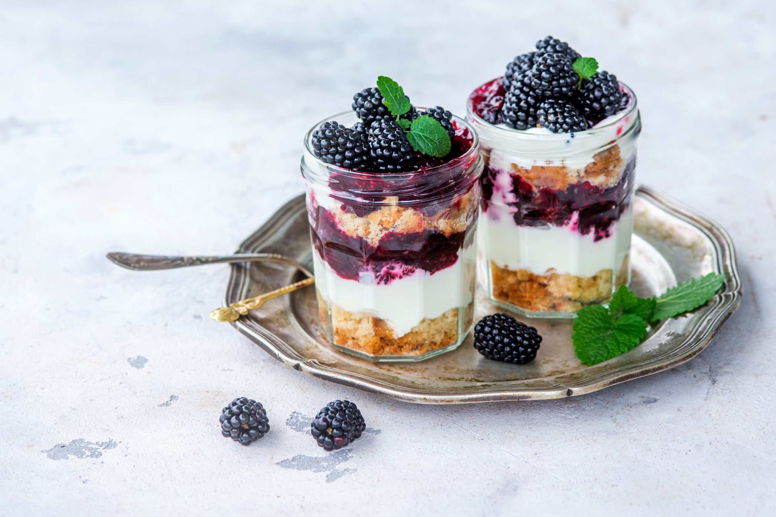 Blackberry Trifle: This summer trifle is layered with crumbly cubes of orange pound cake, orange liqueur, creamy custard, blackberry compote (blackberries simmered with a little sugar, orange zest, and orange juice), whipped cream, fresh blackberries, and mint leaves for decoration. Macaroons are a good substitute for the cake. 
