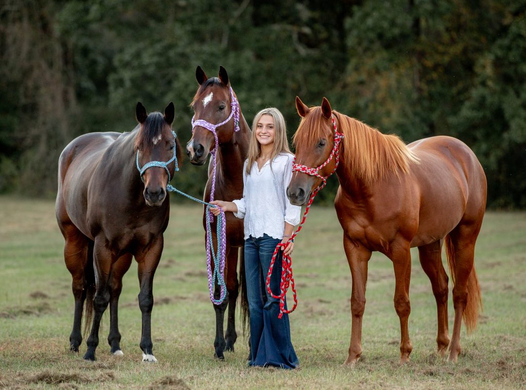 Seventeen-year-old Kylie Snelgrove with her three barrel horses — Sage on the left, Swag in the middle, and Rita on the right. Kylie says, “Riding over the years, you create that bond and trust with the horse. I think that is what Swag and I really have. She is a really sweet horse and taught me a whole lot.” 