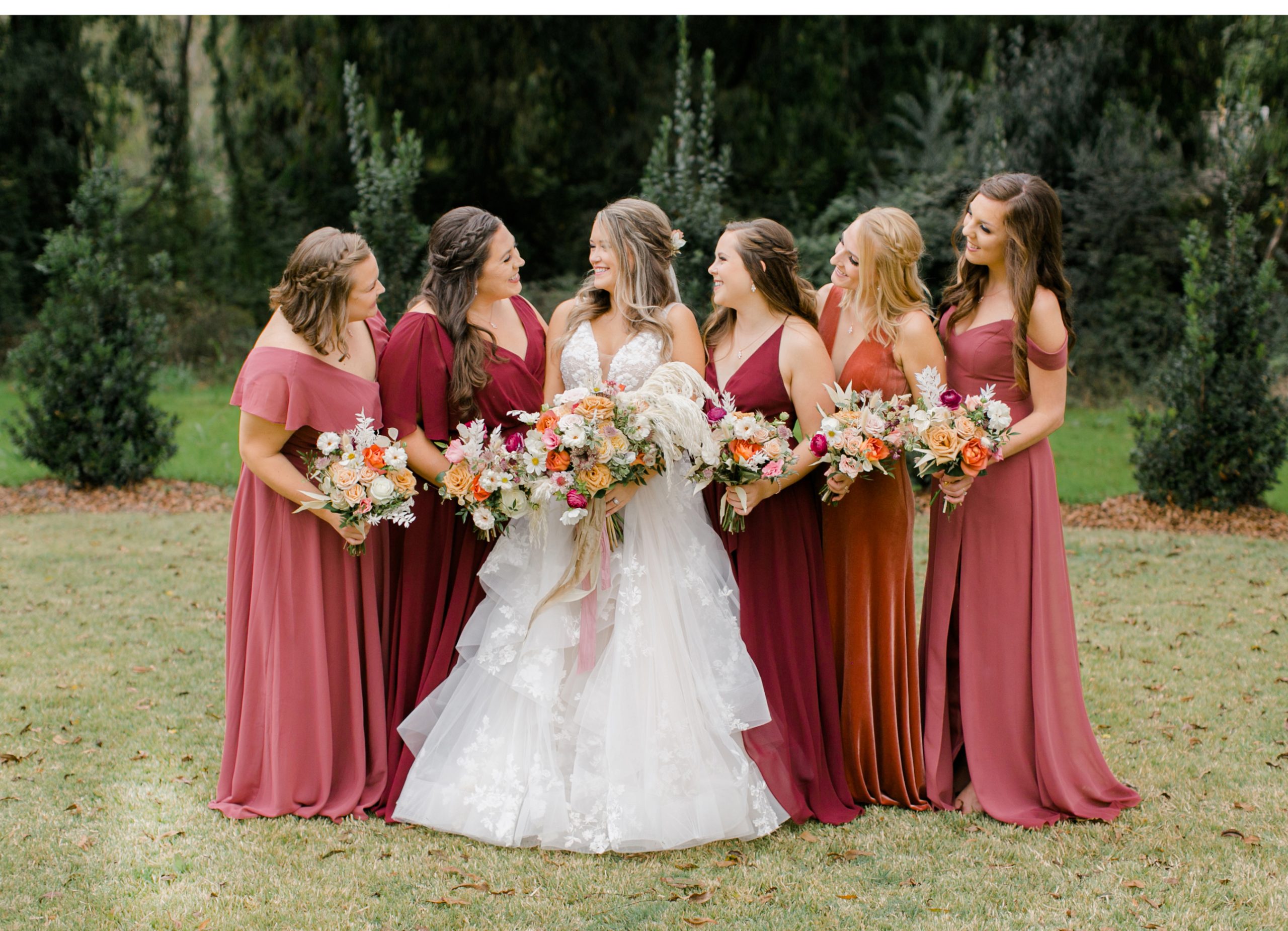 A popular and mutually agreeable new trend for bridal attendants is to choose dresses that do not match in style or even necessarily in color. Bridesmaids can wear dresses they like and that they are likely to wear again. Touchable fabrics and flattering colors make each one feel beautiful.  Sydney Thompson, Hannah Link, Bride Katherine Garrett, Maid of Honor Caroline Kammer, Lexie Barr, and Megan Garrett. The bridesmaid dresses were sourced from Bella Bridesmaid.