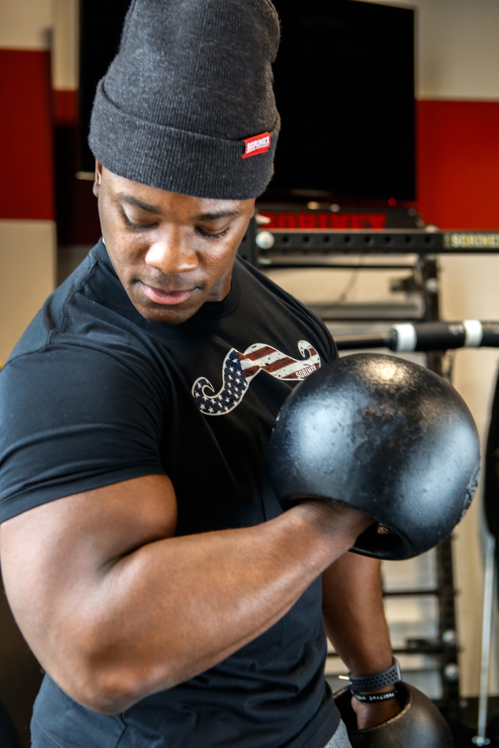 Because Sorinex also provides equipment to the U.S. military, the company was deemed essential by the government during COVID. Alex Goode does a curl with one of Sorinex’s Center Mass Bells. 